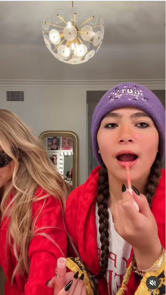 Mariah Carey's 14-year-old daughter, Monroe applying lipstick on her lips from a video posted on August 5, 2025 | Source: Instagram/mariahcarey