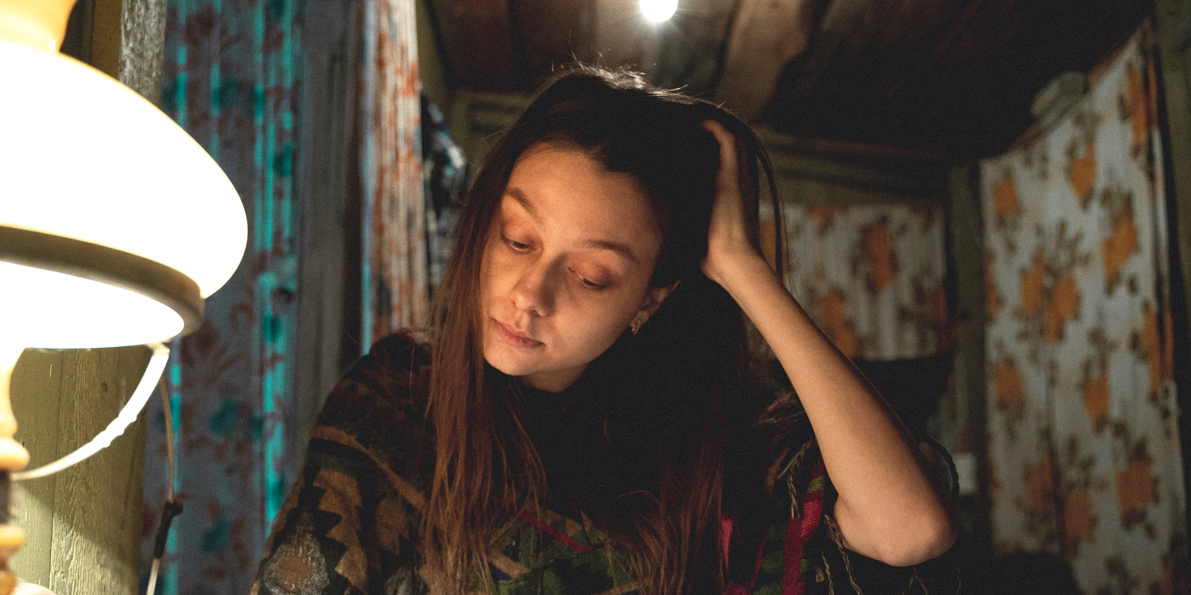 Teenage girl decorating her dark room in the basement | Source: Midjourney