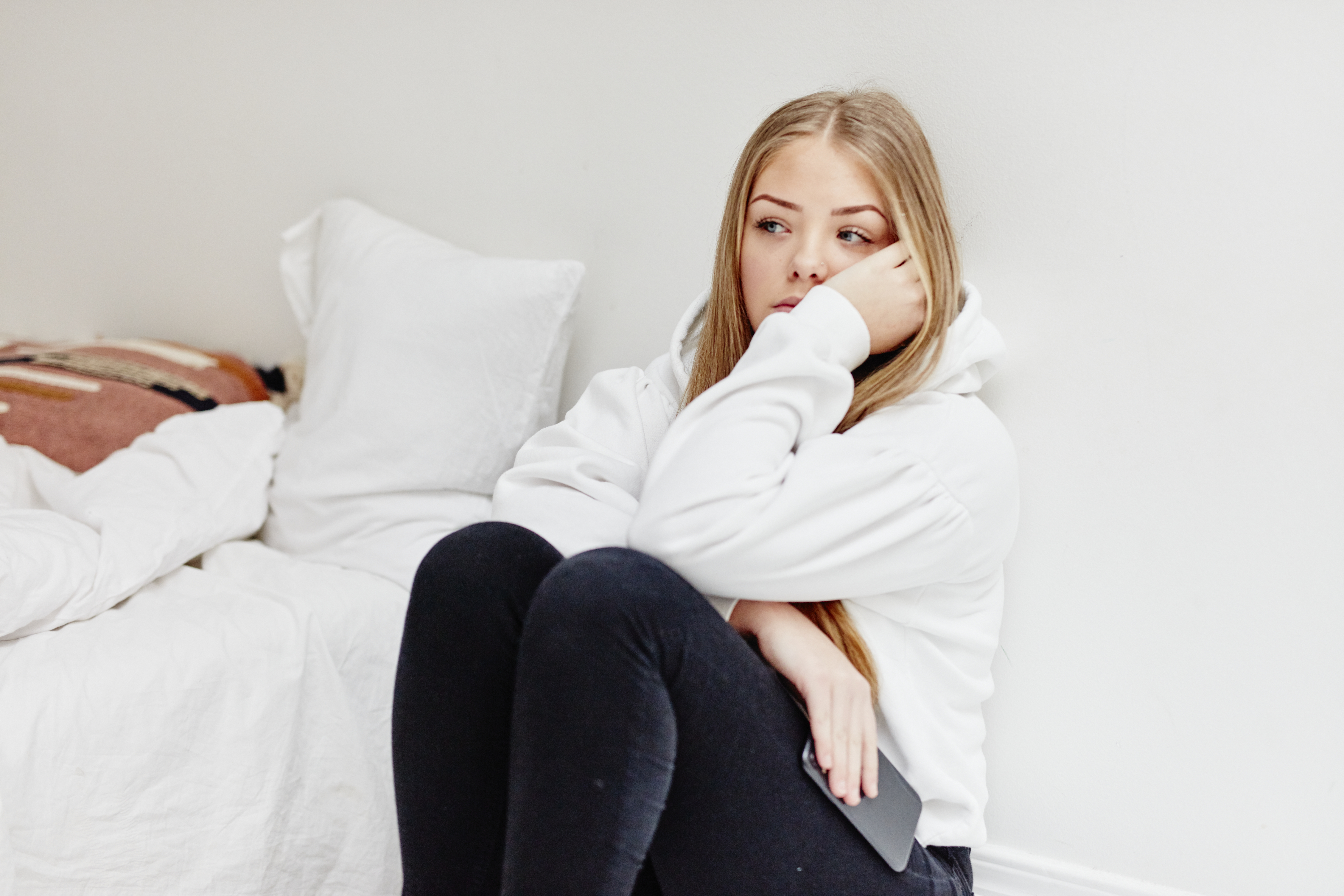 Worried woman sitting in bedroom | Source: Getty Images