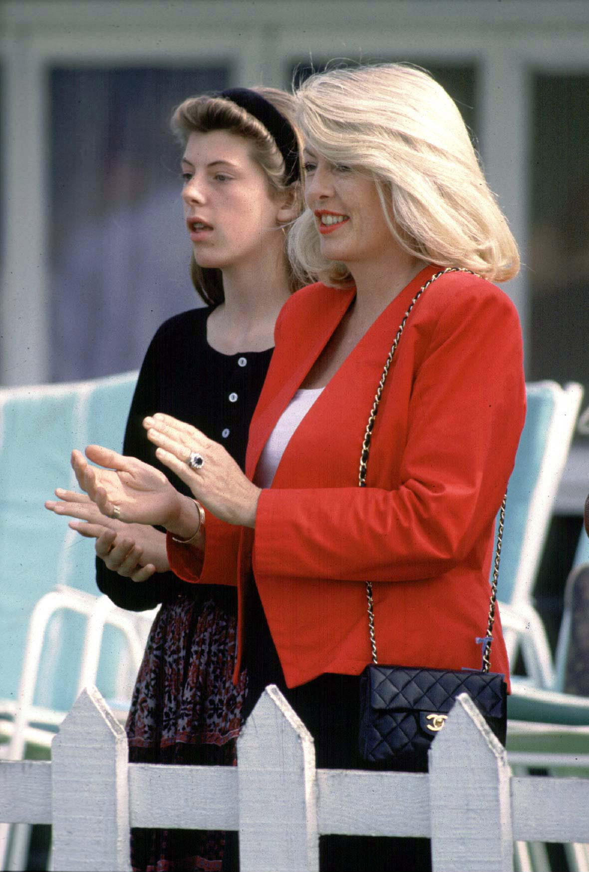Lady Dale Tryon watching Prince Charles at Smiths Lawn, Windsor with her daughter Zoe on September 22, 1990| Source: Getty Images