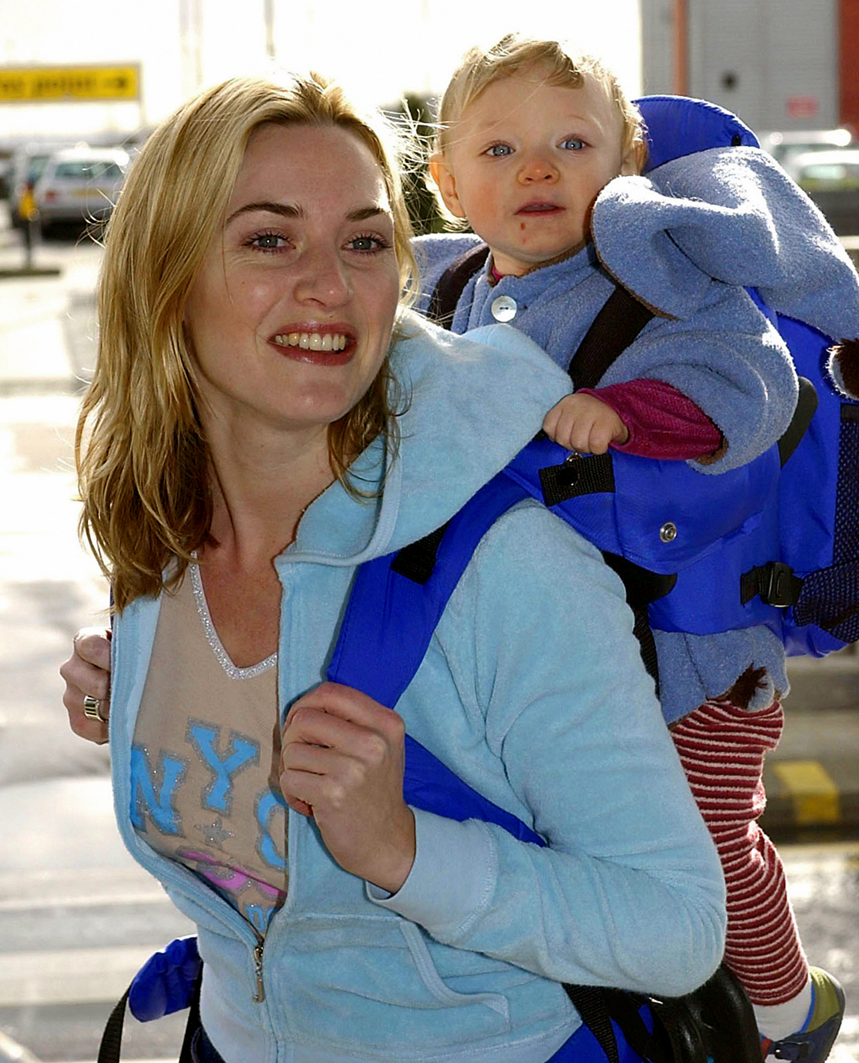 Kate Winslet and Mia Threapleton at London's Heathrow Airport on February 26, 2002 | Getty Images