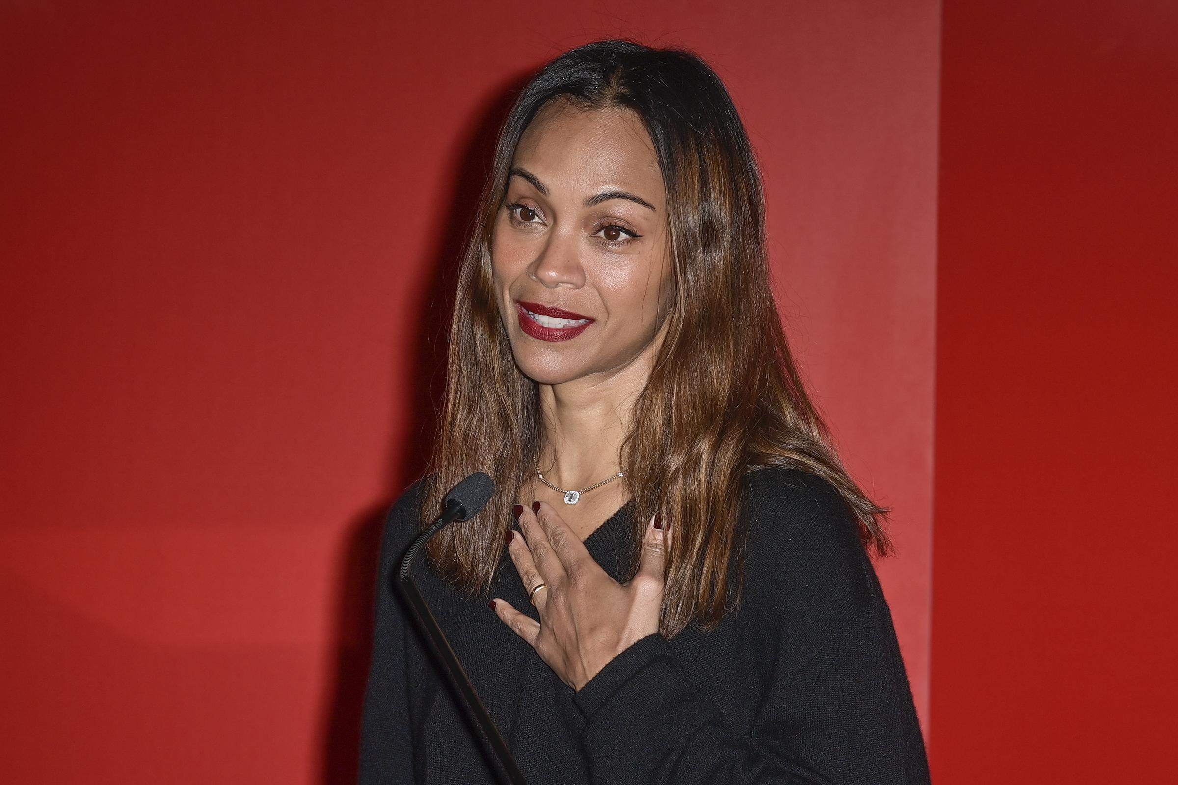 Zoe Saldaña speaking during the "Emilia Perez" premiere. | Source: Getty Images