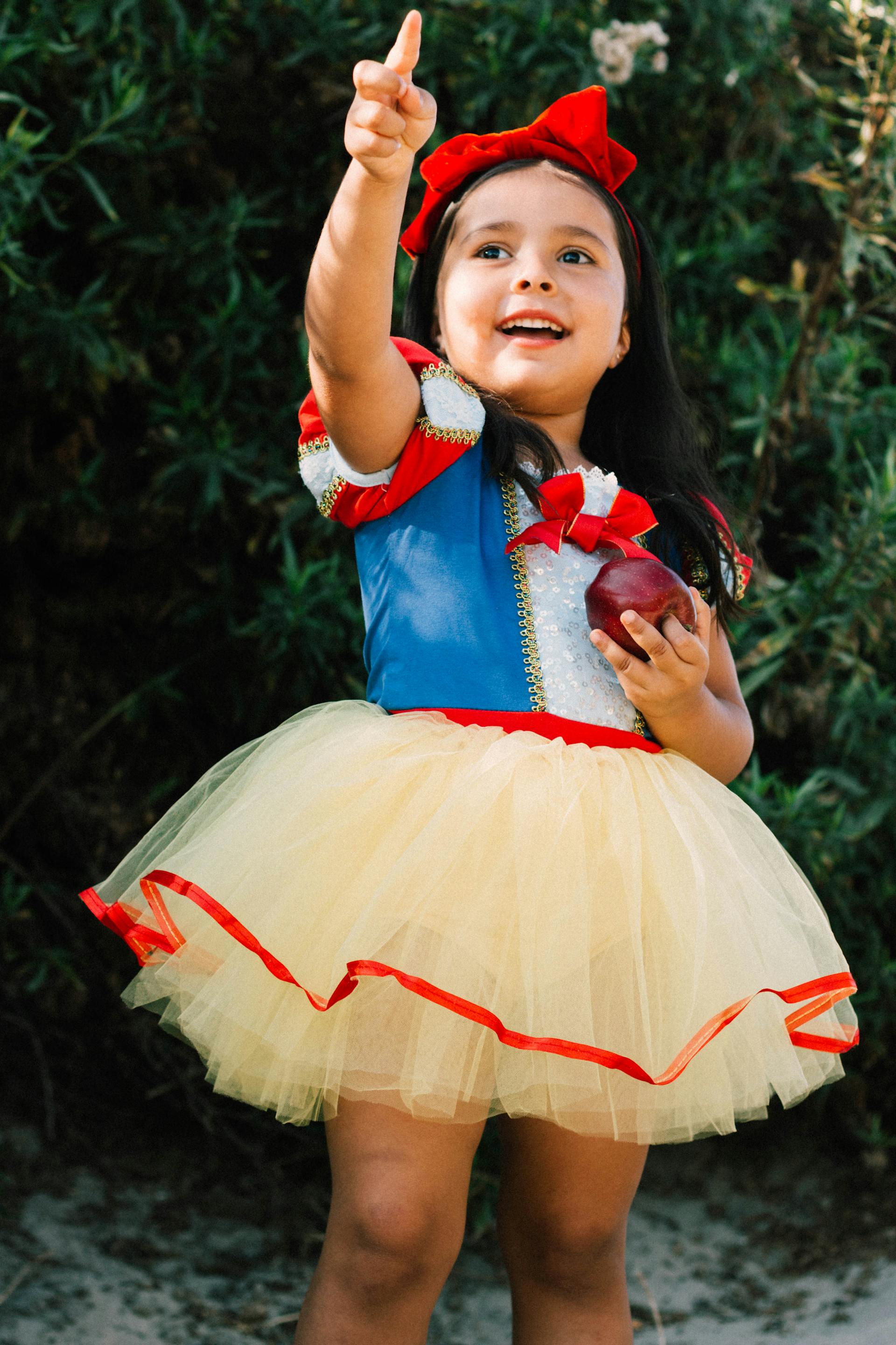 A smiling little girl in a princess costume | Source: Pexels