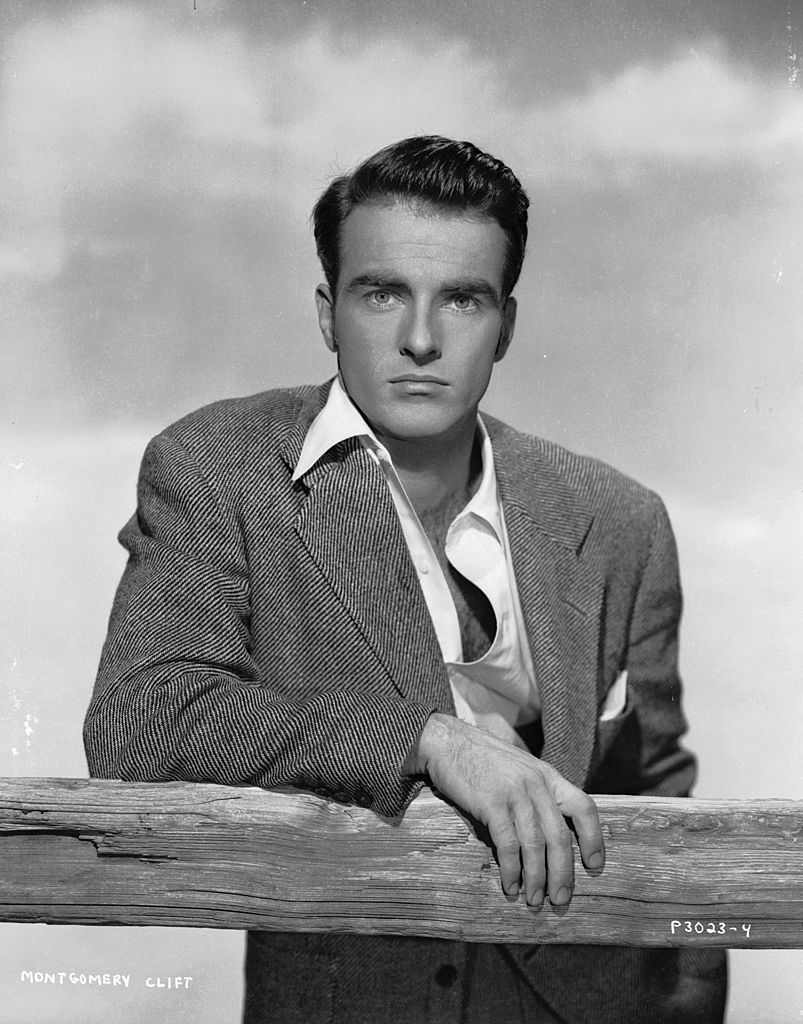 A portrait of Montgomery Clift leaning on a fence with an intent expression before his accident on 01 January, 1950 | Photo: Getty Images