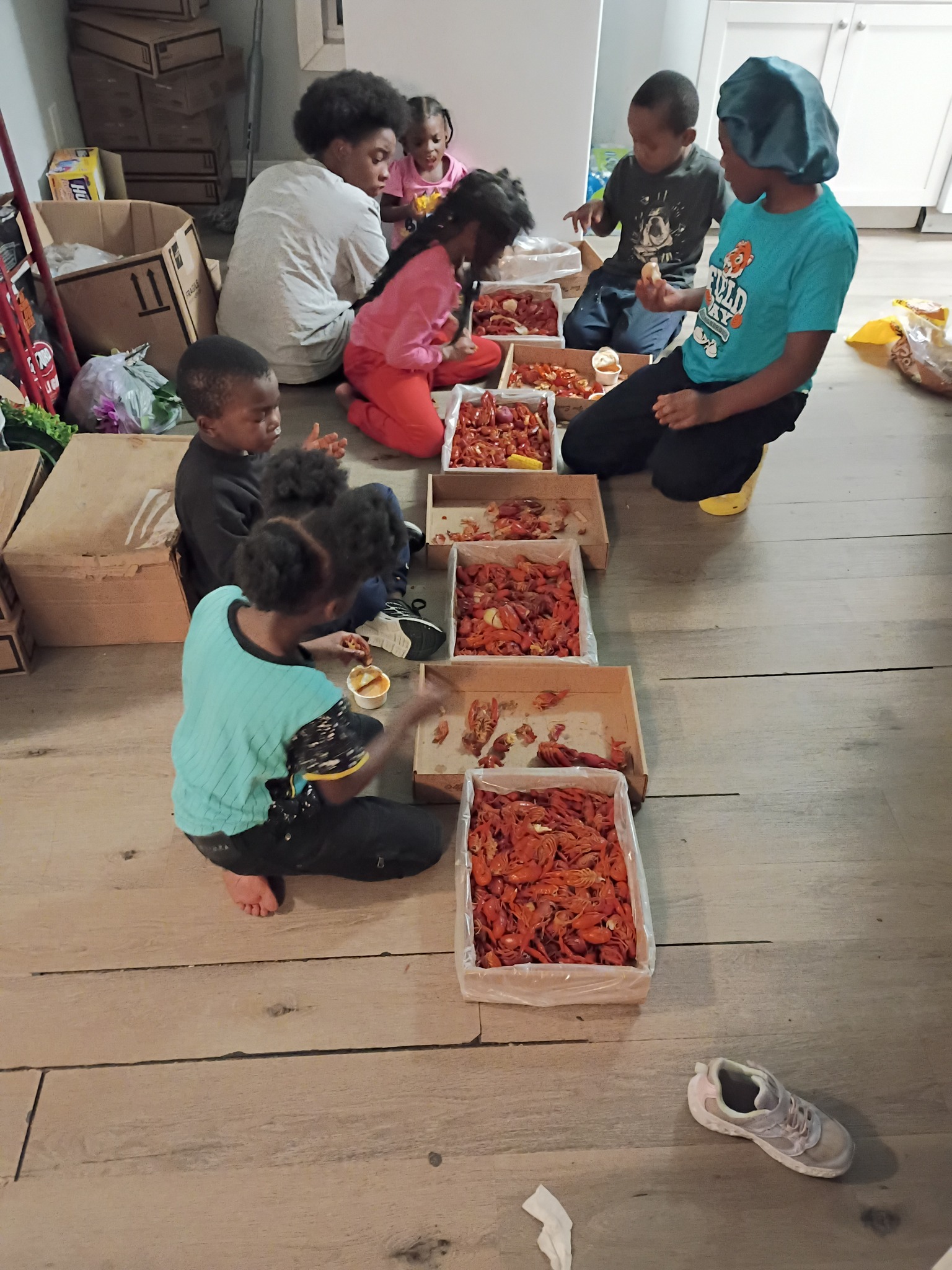 Shamar Elkins' children gathered around boxes of food, posted on February 13, 2026. | Source: Facebook/Shamar Elkins