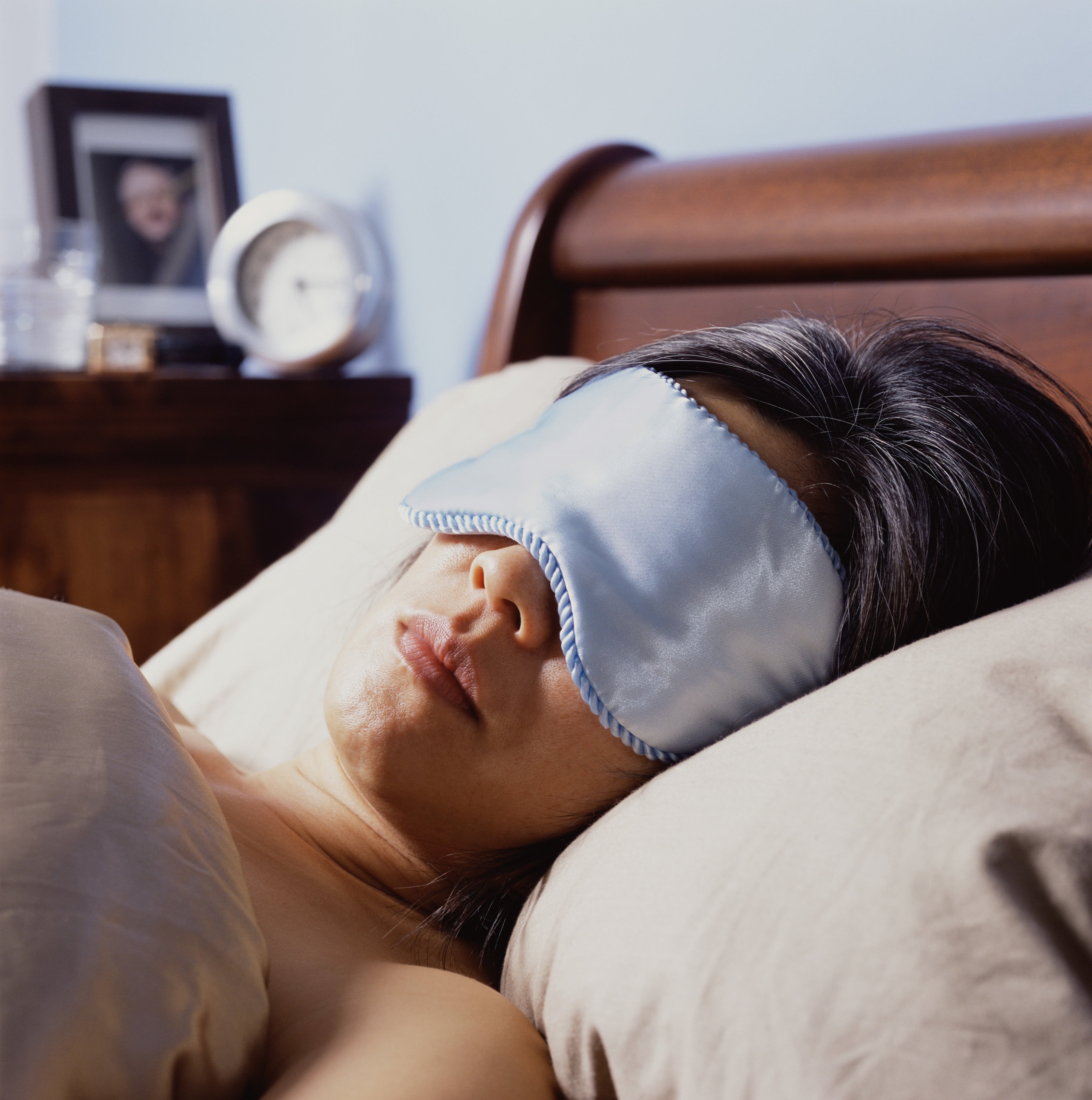 A close up of a woman sleeping with an eye mask | Source: Getty Images