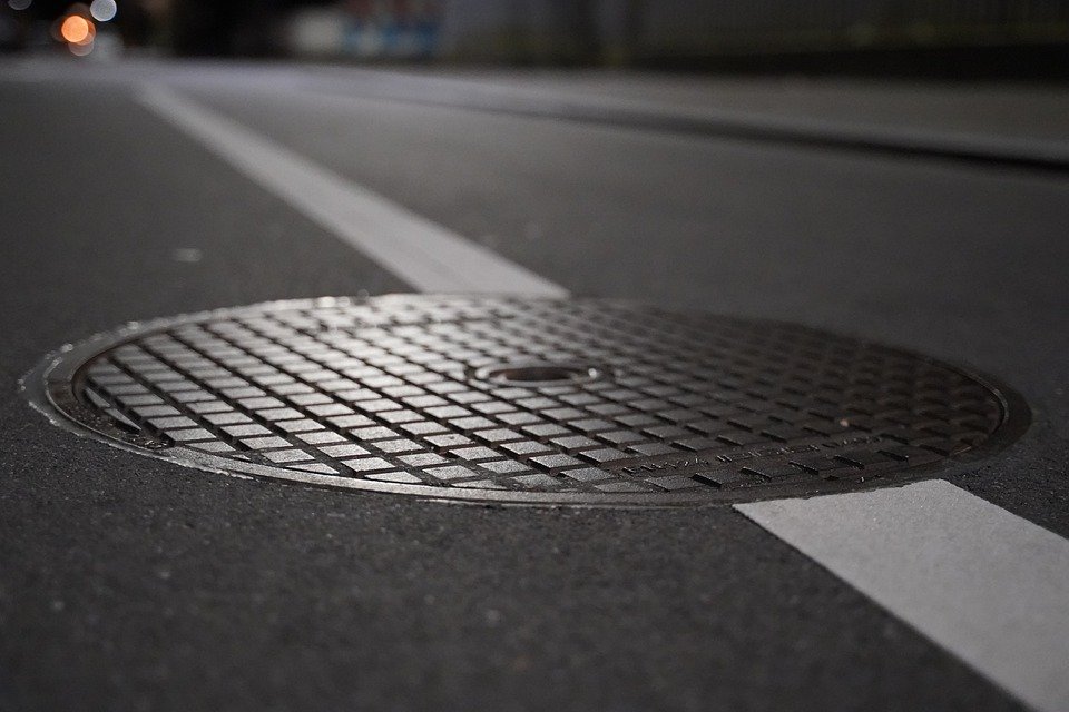 A manhole cover on the road. | Source: Pixabay