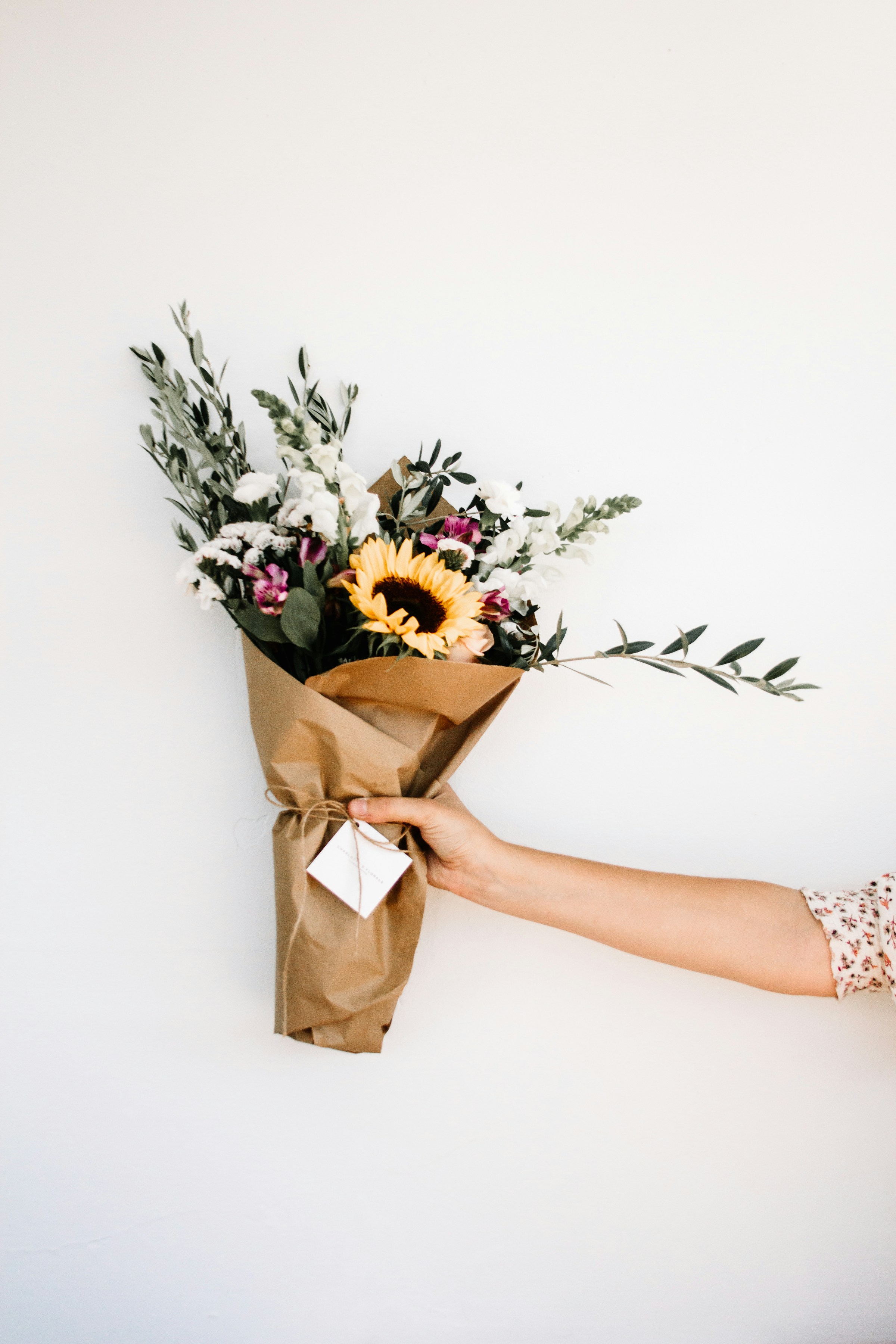 A person holding a bouquet of flowers | Source: Unsplash