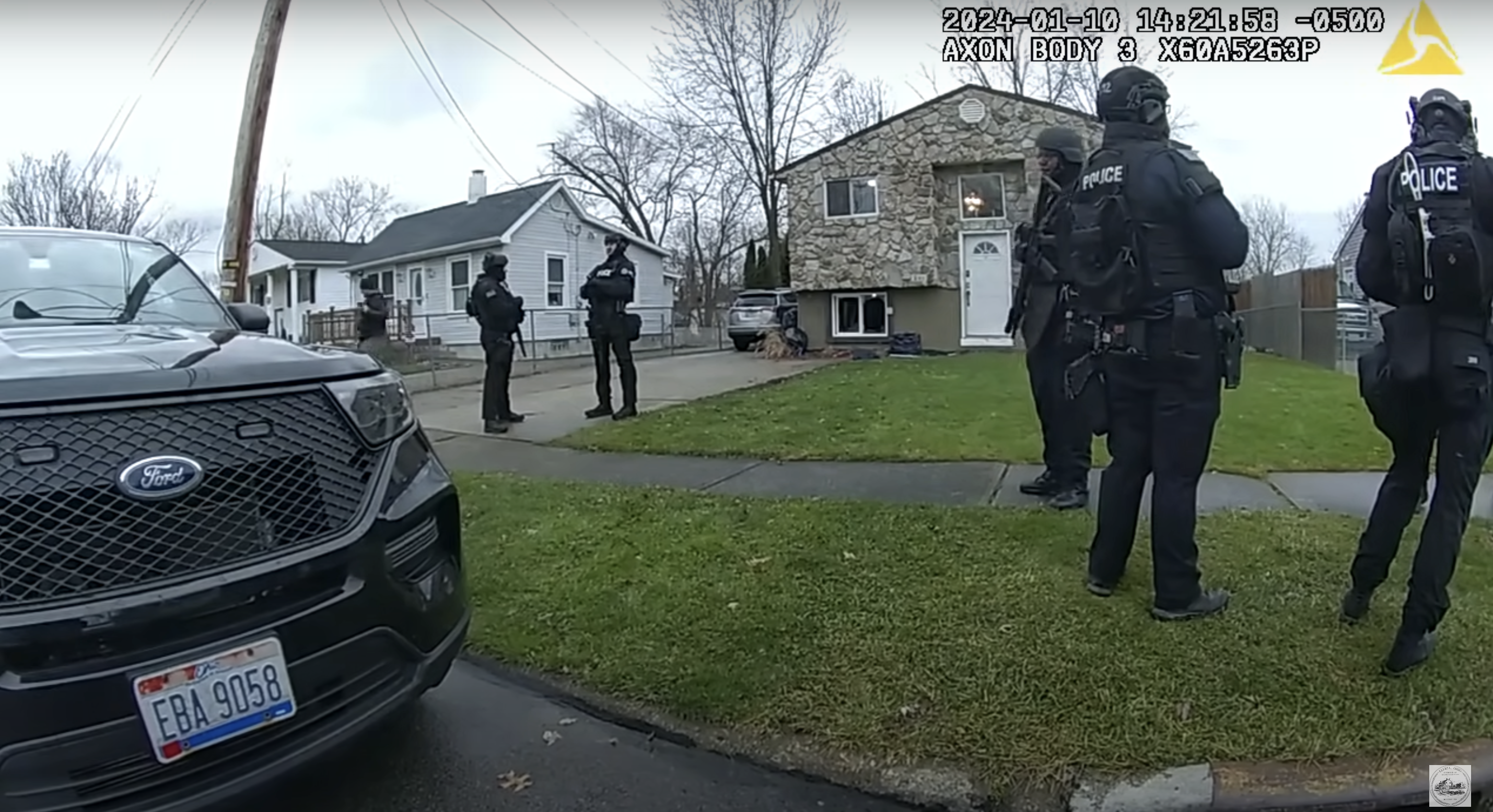 Police officers standing outside the residence of Courtney Price's aunt and uncle, as seen in a video dated January 17, 2024 | Source: youtube.com/CityofElyriaChannel