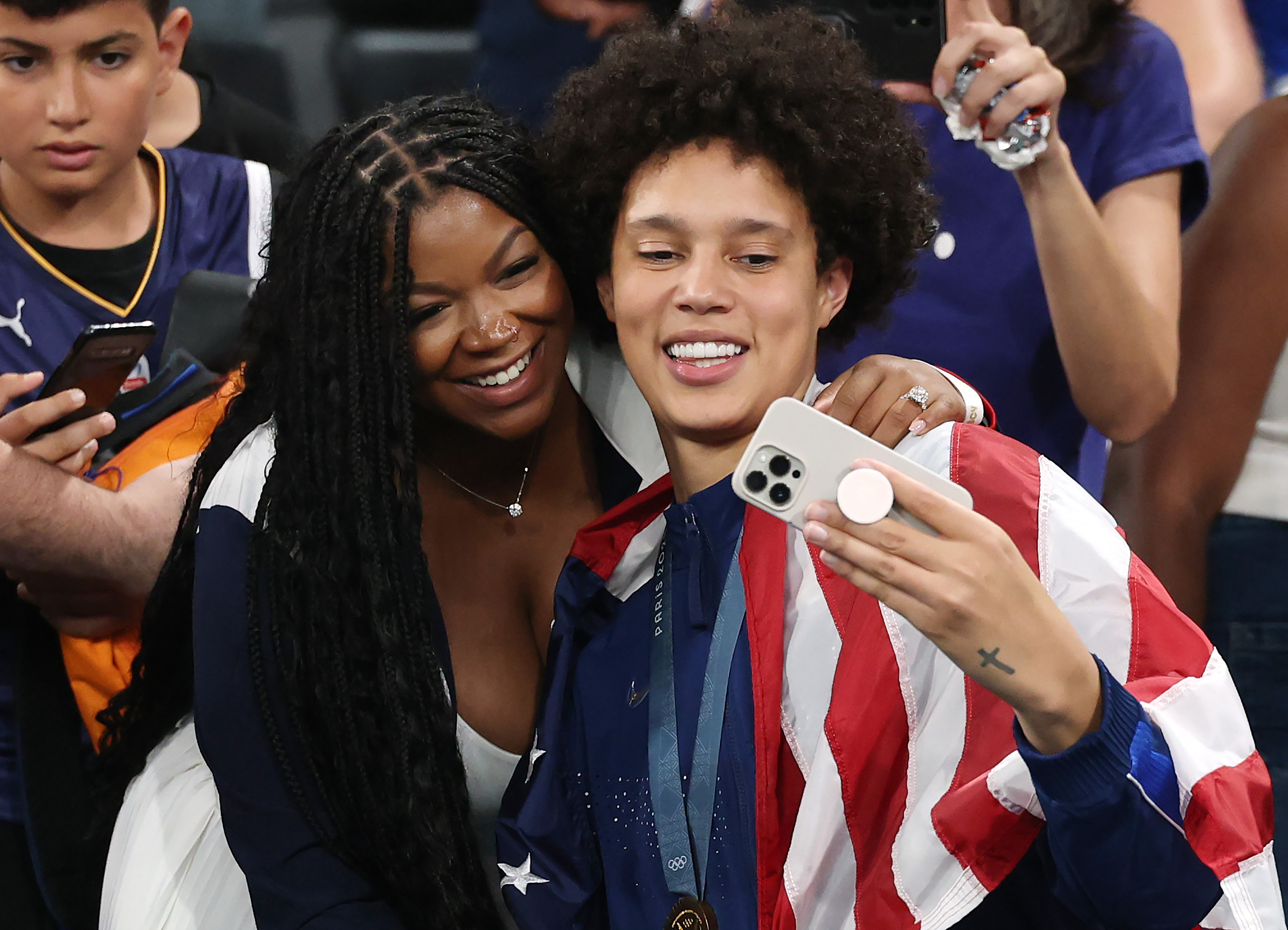 Brittney Griner (#15 of Team United States) takes a selfie with her wife, Cherelle Griner, after Team United States' victory against Team France during the Women's Gold Medal game between Team France and Team United States on day sixteen of the Olympic Games Paris 2024 at Bercy Arena on August 11 in France. | Source: Getty Images