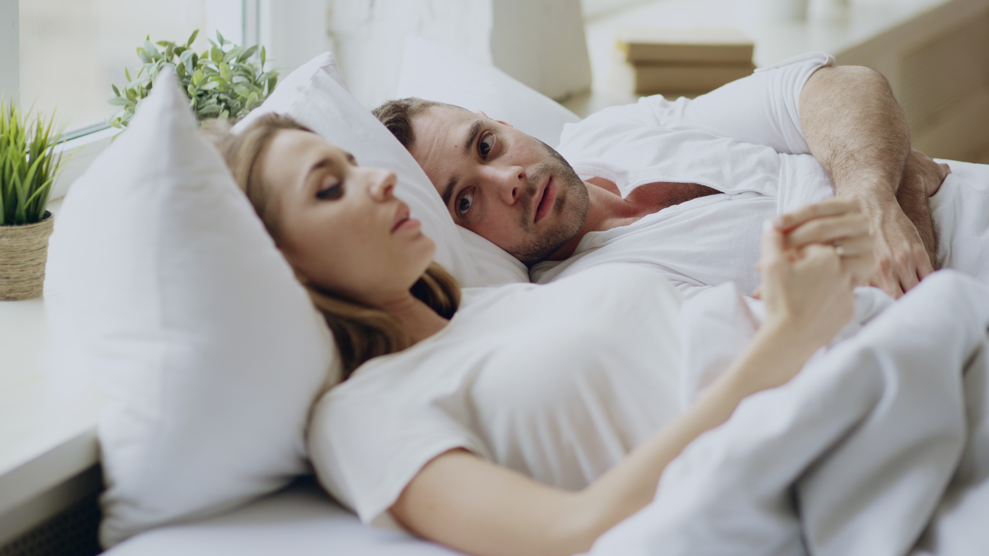 A couple having a conversation in bed | Source: Shutterstock