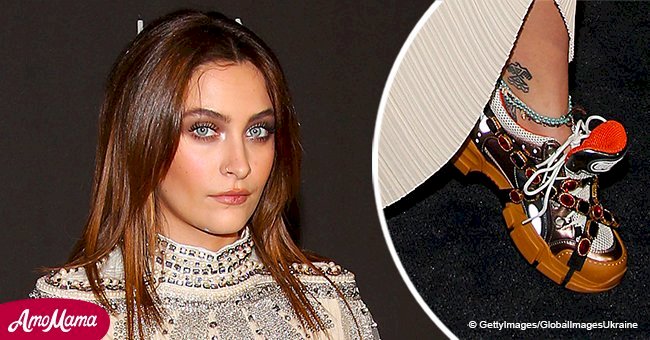 Paris Jackson rocks bizarre toffee-colored trainers combined with a bohemian cream dress