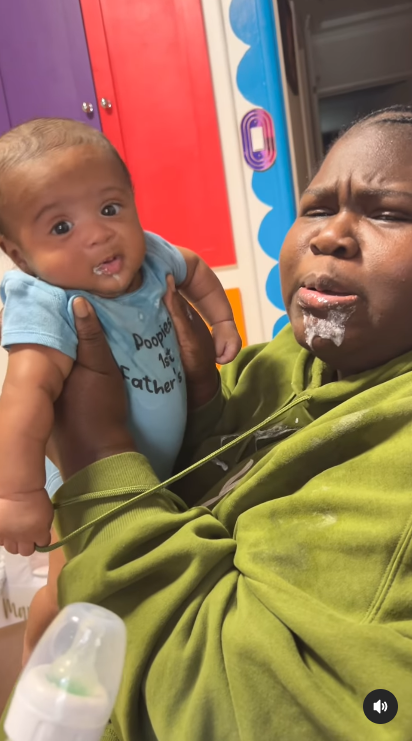 A photo of Gabby Sidibe with milk stains on her mouth while holding her son, Cooper, posted in August 2024 | Source: Instagram/brandontour