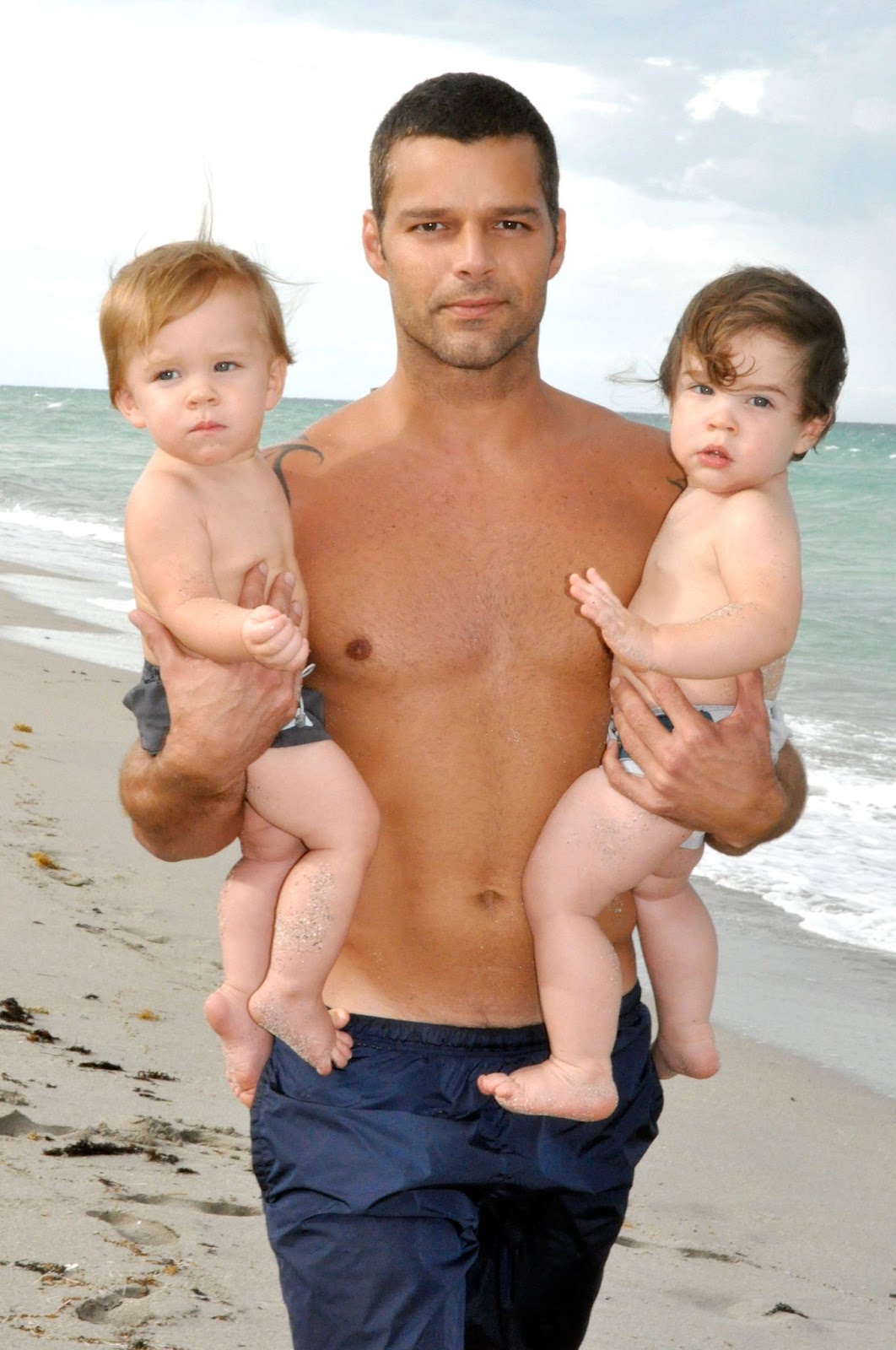 Ricky Martin with his twin sons, Valentino and Matteo, during a relaxed day by the beach in Miami on August 18, 2009. As a hands-on father, Ricky embraced every moment with his boys, cherishing these early years. | Source: Getty Images