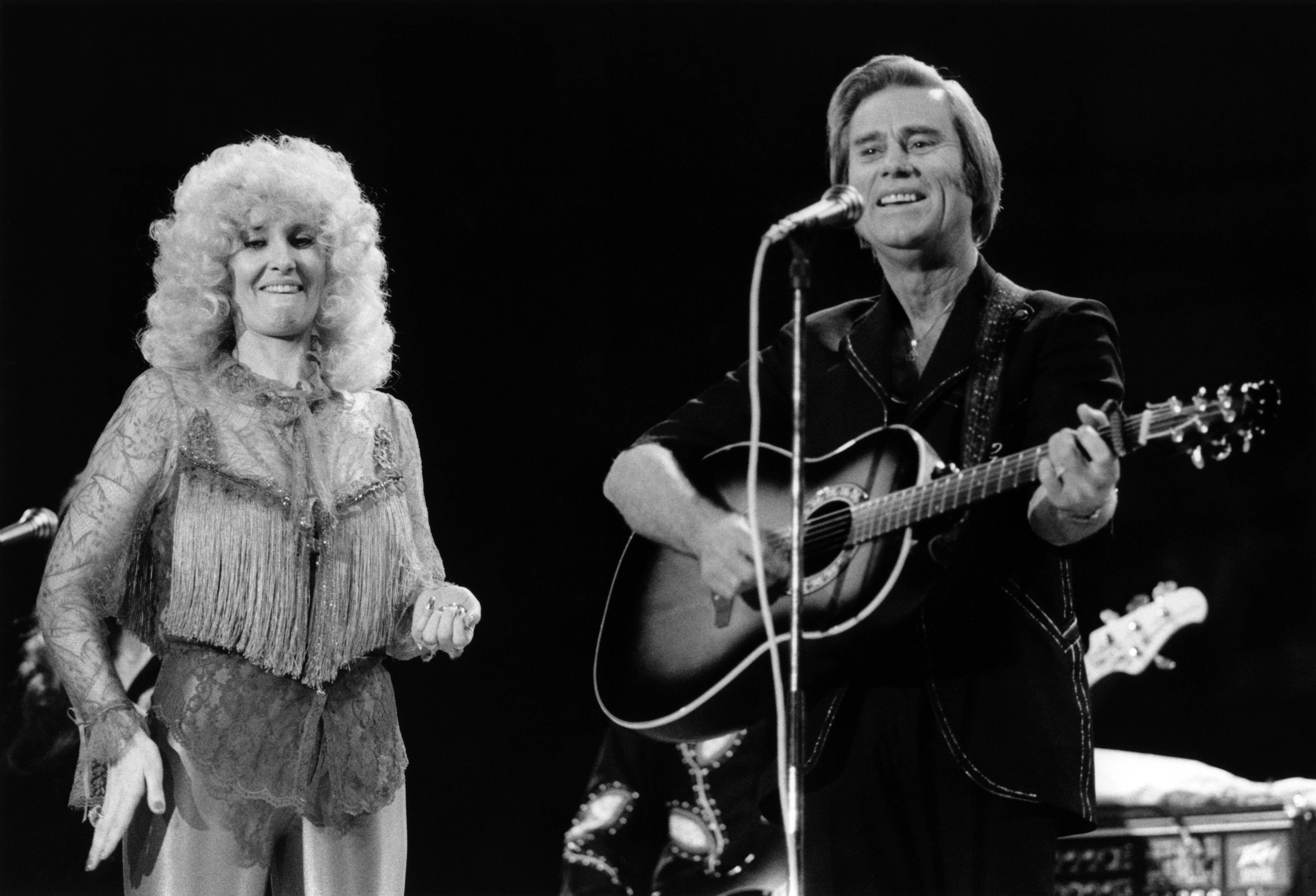 Tammy Wynette and George Jones perform live on stage at the Country Music Festival, Wembley Arena, London in April 1981 | Source: Getty Images