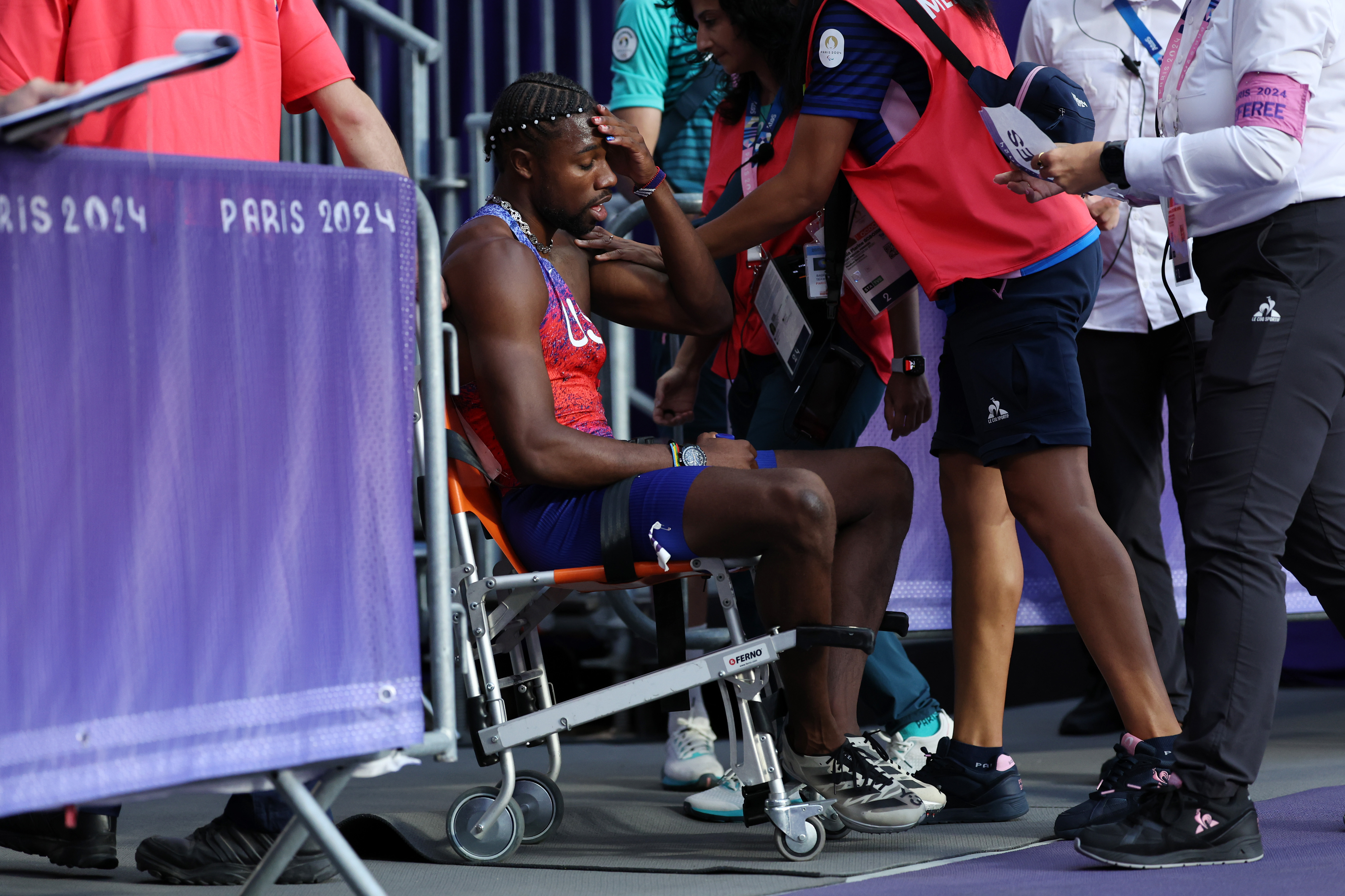 Noah Lyles of the US being taken off from the track with a wheelchair after competing in the Men's 200m Final during the Paris 2024 Summer Olympic Games on August 8, 2024, in Paris, France | Source: Getty Images