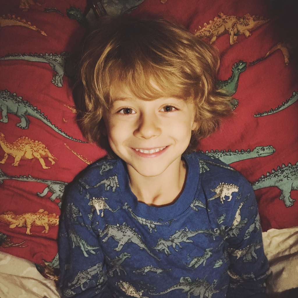 A smiling little boy lying in his bed | Source: Midjourney