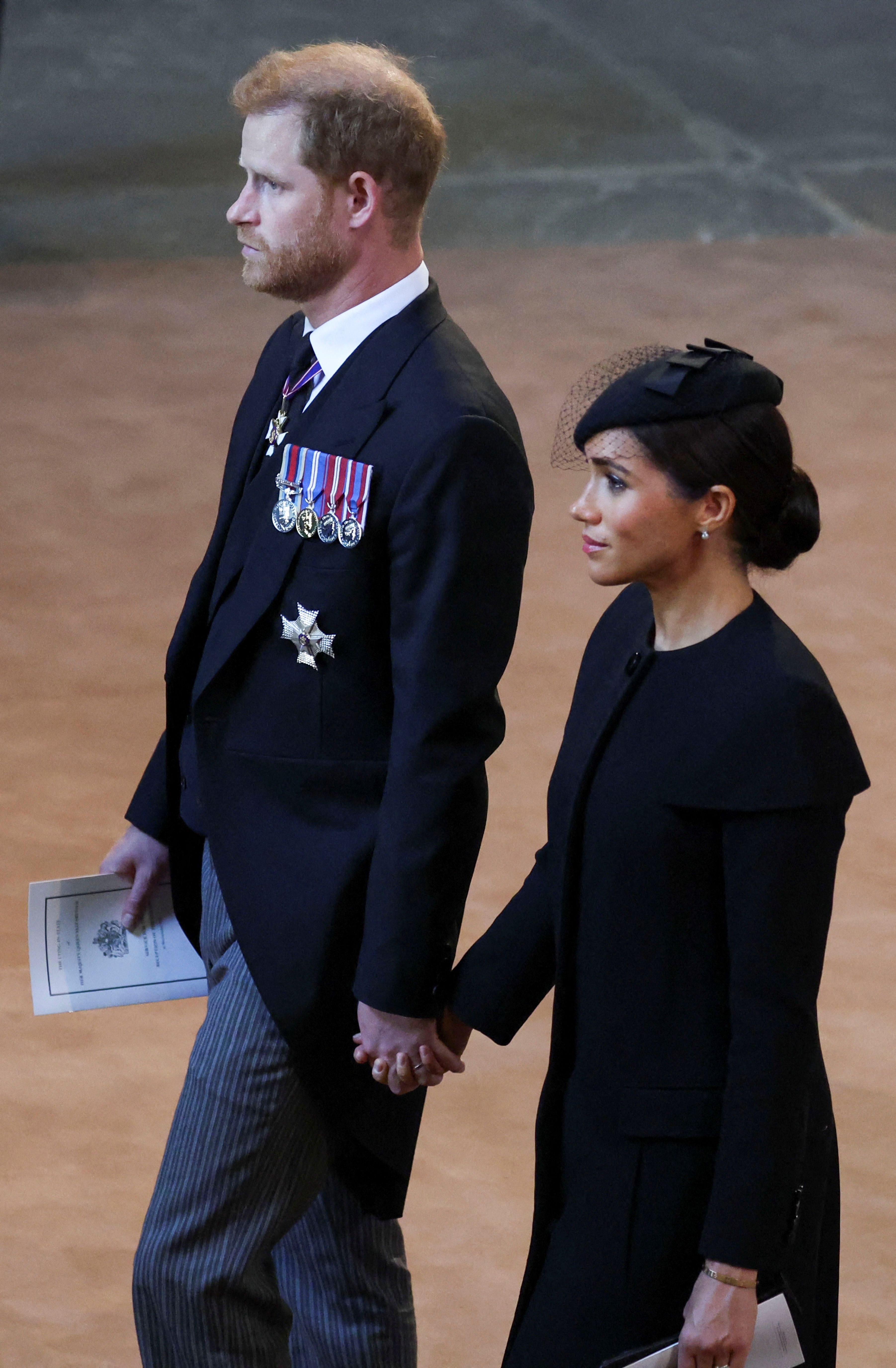 Prince Harry and Duchess Meghan leave after a service for the reception of Queen Elizabeth II's coffin at Westminster Hall, in the Palace of Westminster in London on September 14, 2022 | Source: Getty Images