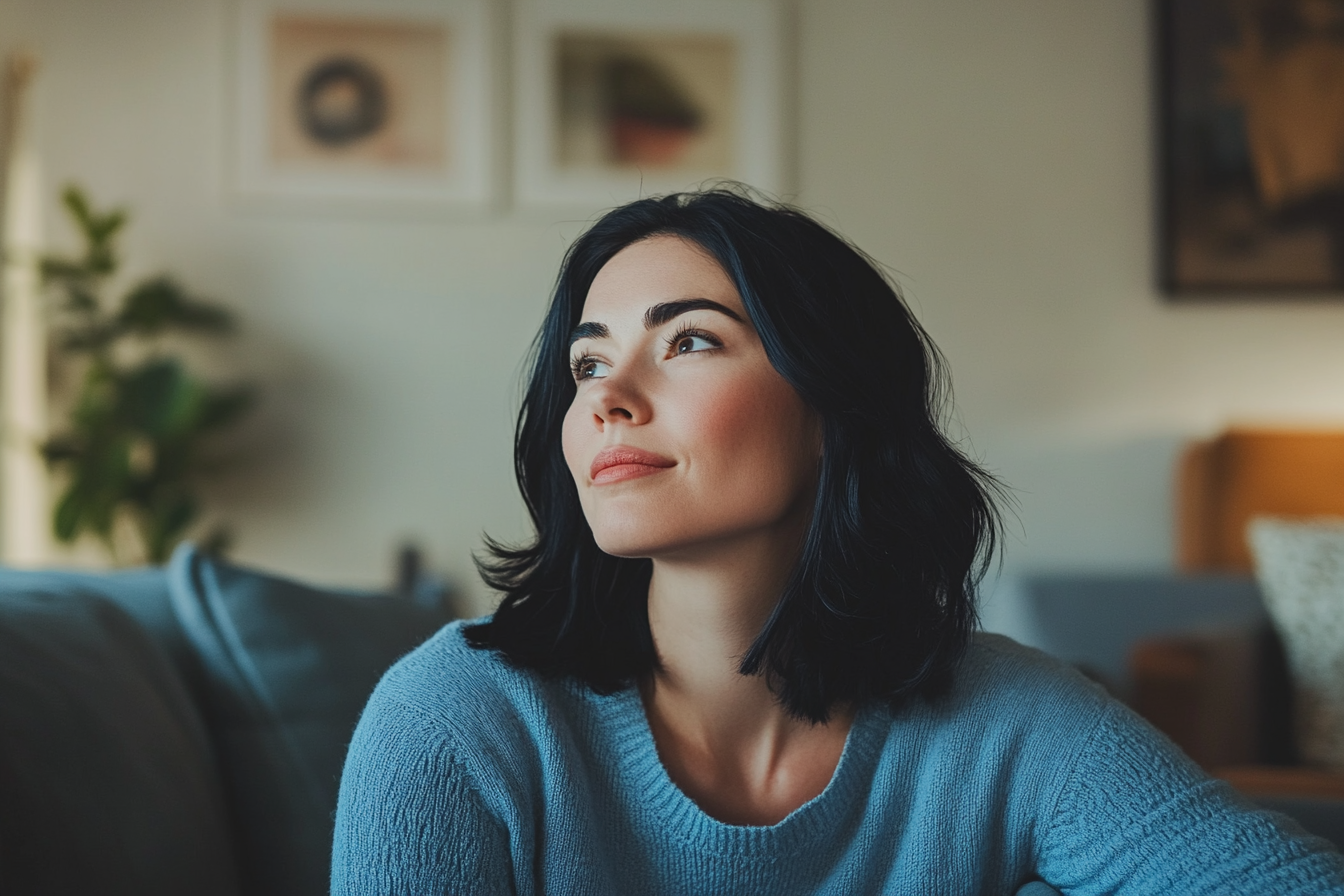 A woman sitting in her living room | Source: Midjourney