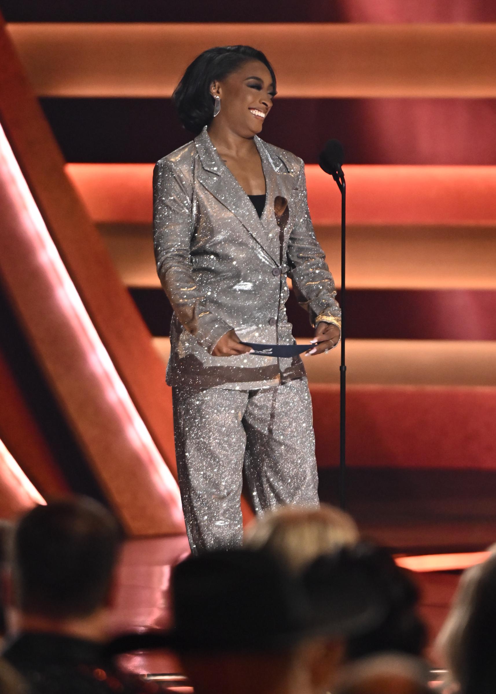 Simone Biles speaking on stage at the CMA Awards. | Source: Getty Images