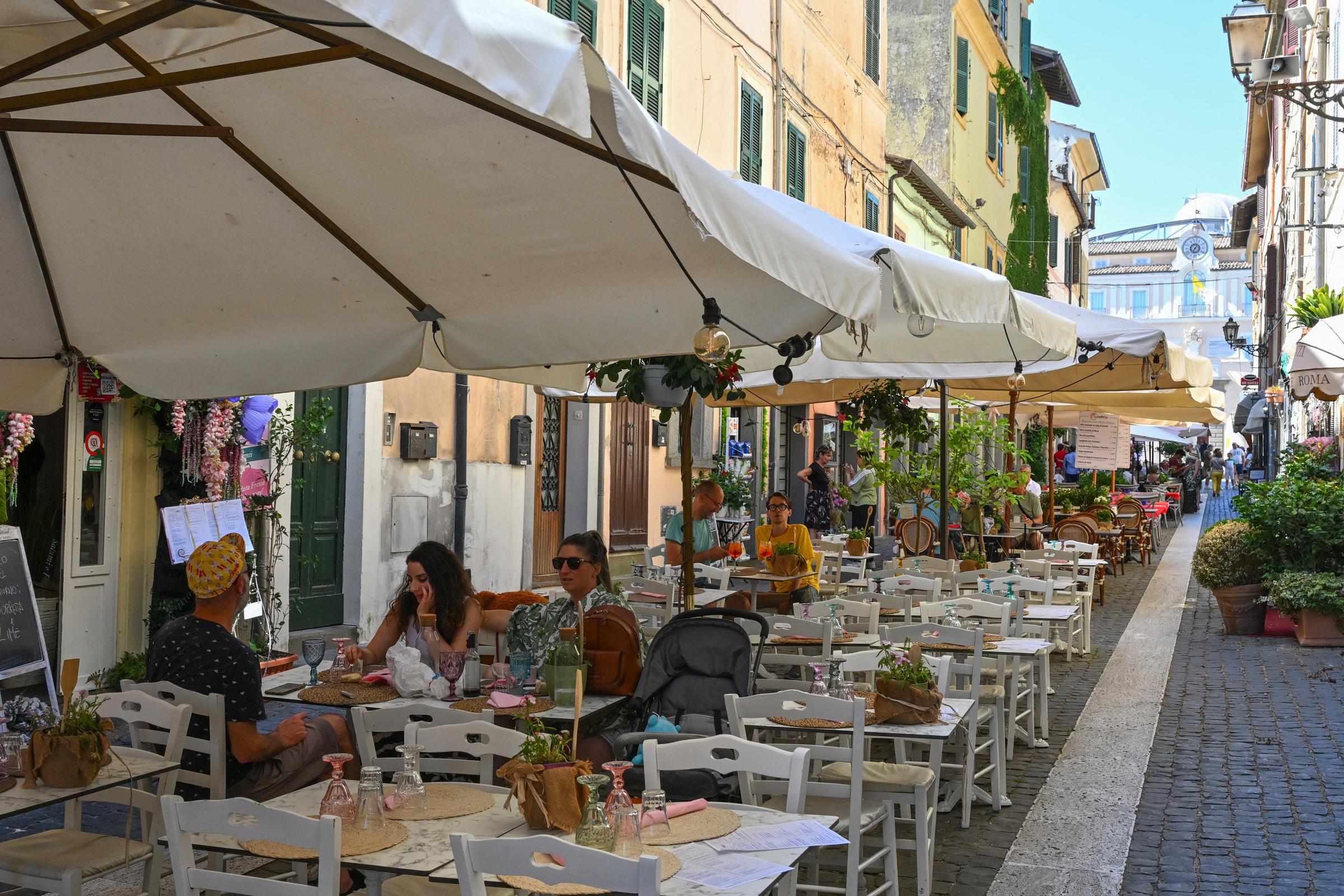 Patrons sit on the terrace of a restaurant on July 6, 2025, in Castel Gandolfo, Italy. | Source: Getty Images