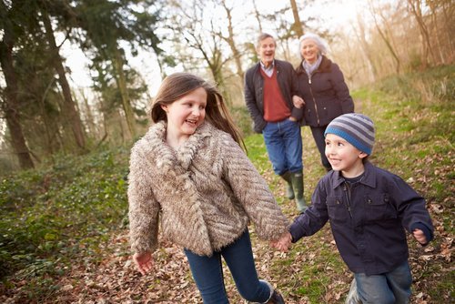 Grandparents with their grandchildren out on a walk. | Source: Shutterstock. Grandparents with their grandchildren out on a walk. | Source: Shutterstock.
