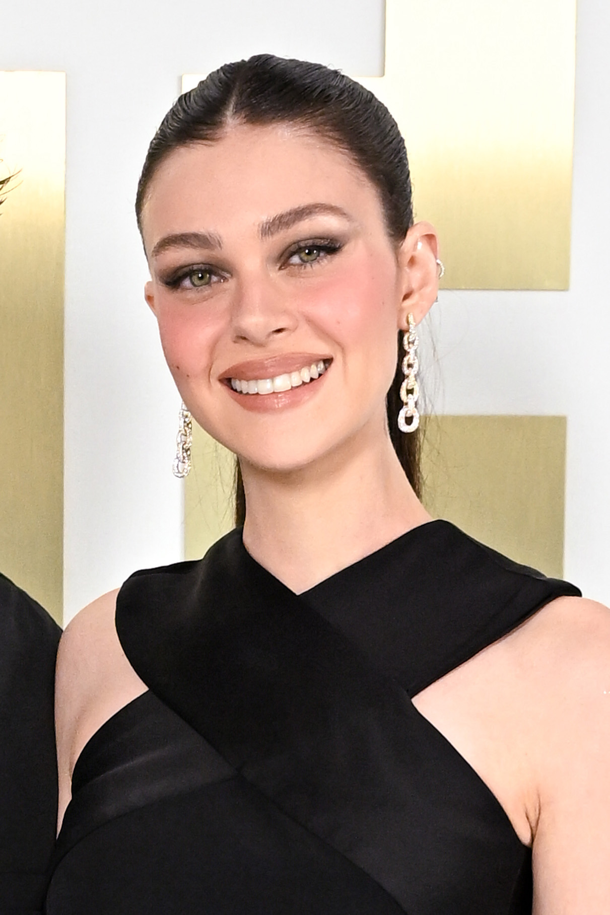 Nicola Peltz oozed effortless Parisian glamour as she turned heads at Balmain’s Womenswear Spring-Summer 2025 show, commanding the spotlight in a sculpted black dress that hugged her frame. With her hair slicked back to perfection and shimmering statement earrings catching every flashbulb, she lit up Paris Fashion Week on 25 September 2024.