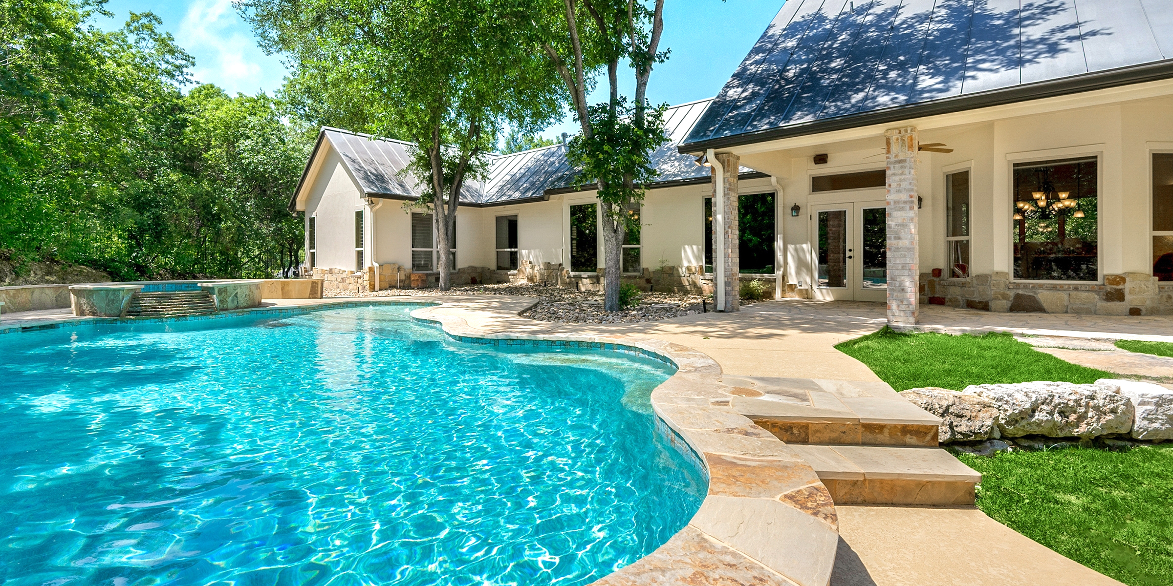 Swimming pool next to a beautiful house | Source: Shutterstock