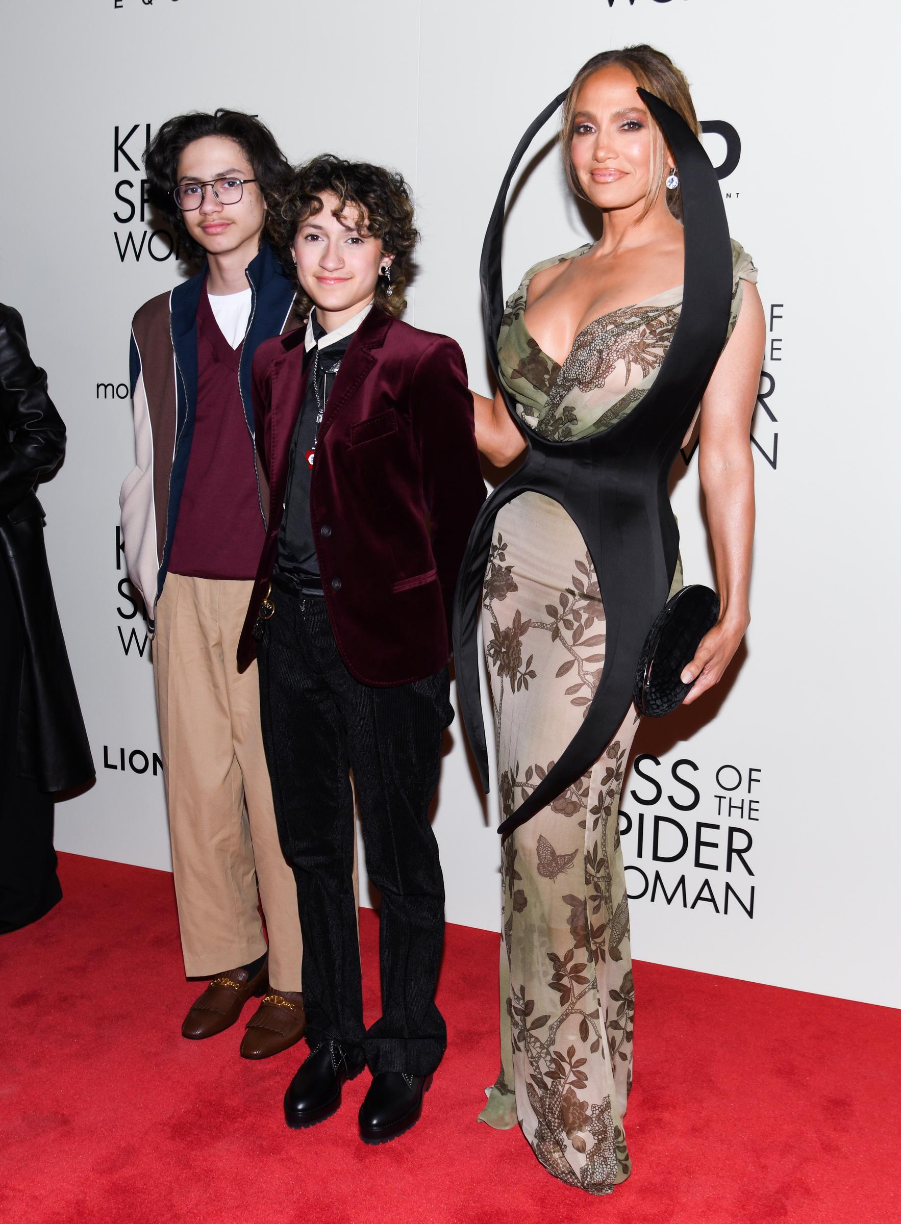 Max, Emme, and Jennifer Lopez attend the "Kiss of the Spider Woman" screening at The Shed in New York. All three share subtle smiles, looking elegant in their red-carpet-worthy outfits as they celebrate Jennifer’s new film.