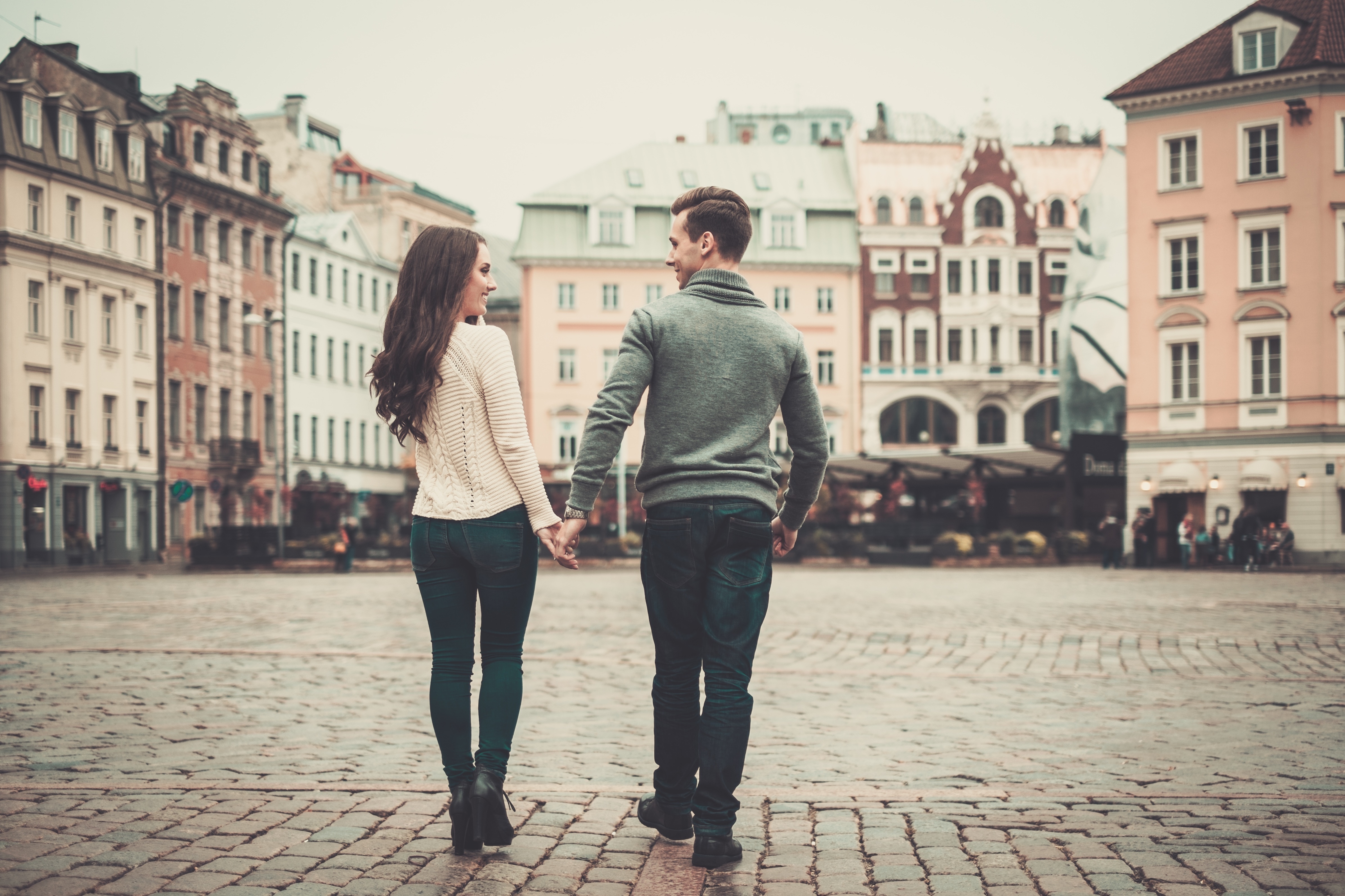 A couple walking while holding hands | Source: Shutterstock