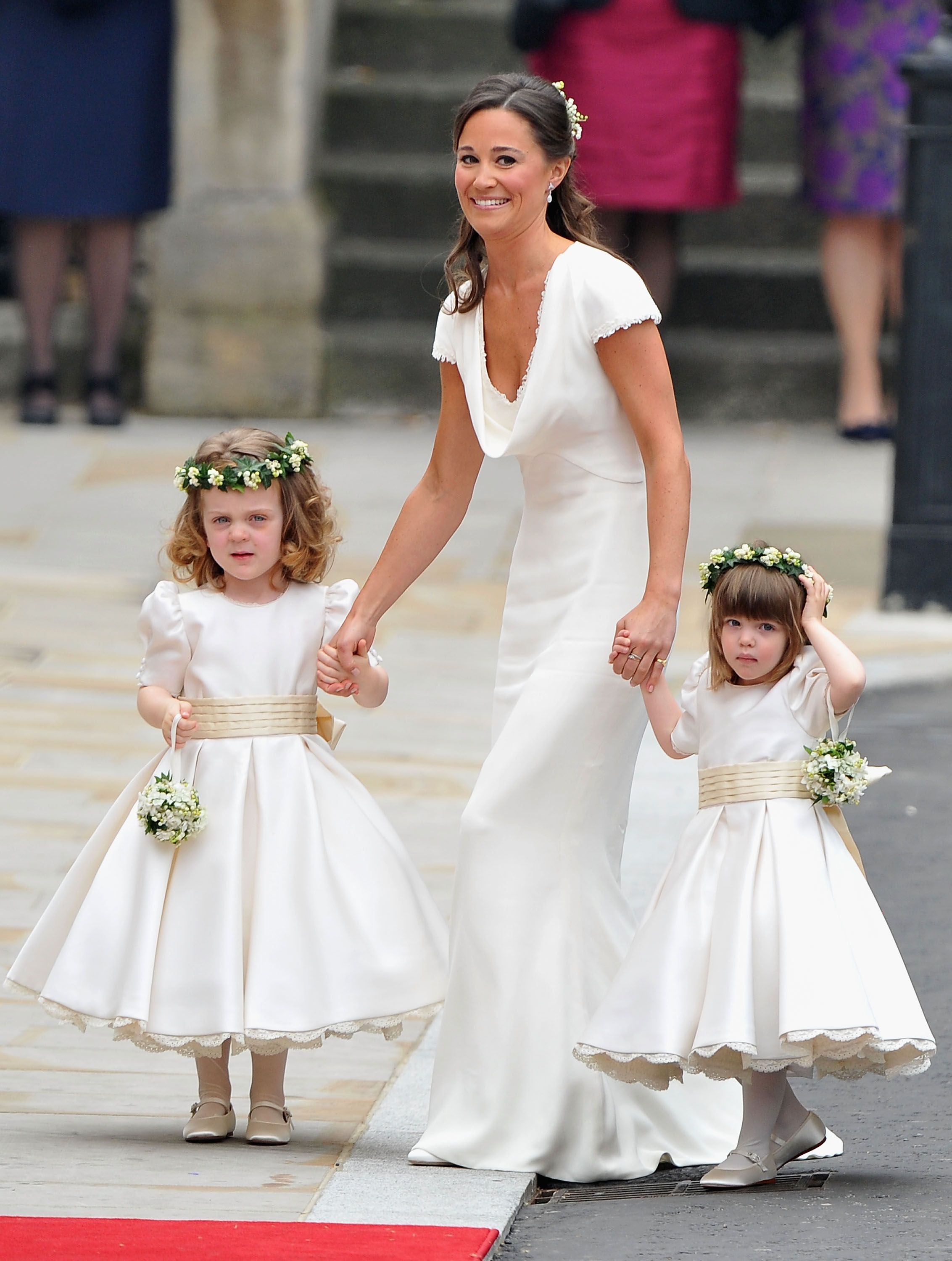 Sister of the bride and Maid of Honour Pippa Middleton holds hands with Grace Van Cutsem and Eliza Lopes as they arrive to attend the Royal Wedding of Prince William to Catherine Middleton at Westminster Abbey on April 29, 2011 | Photo: Getty Images