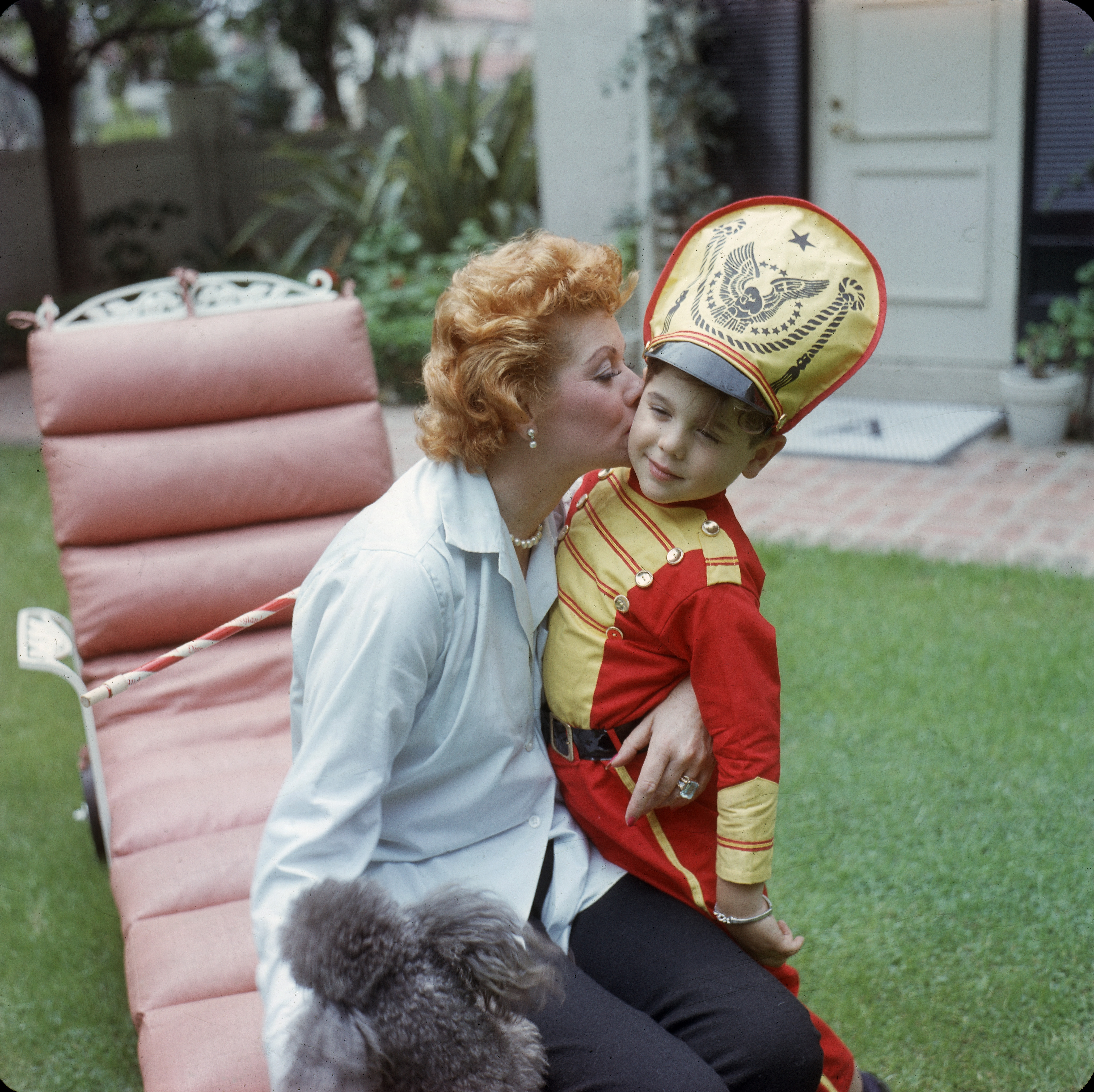 Lucille Ball and Desi Arnaz Jr. in the back yard of their home, in Los Angeles, California, in 1957 | Source: Getty Images