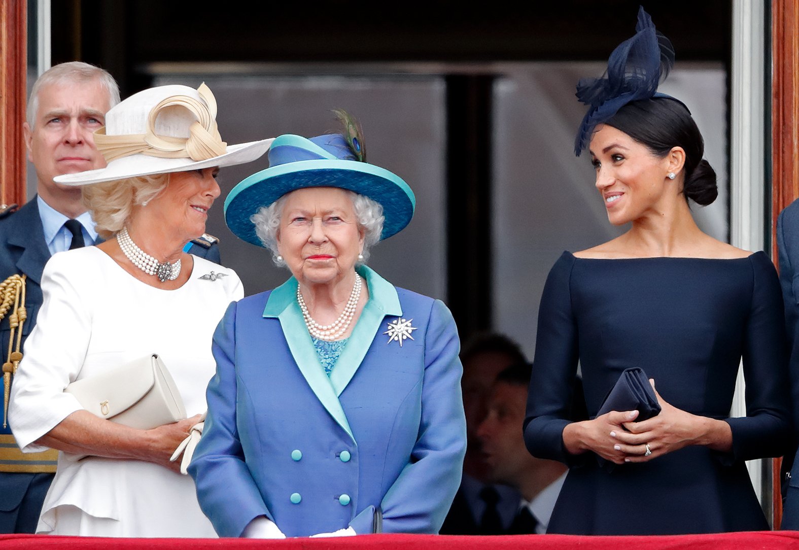 Duchess Camilla, Queen Elizabeth II, and Duchess Meghan watch a flypast to mark the Royal Air Force's centenary from Buckingham Palace's balcony on July 10, 2018, in London, England. | Source: Getty Images