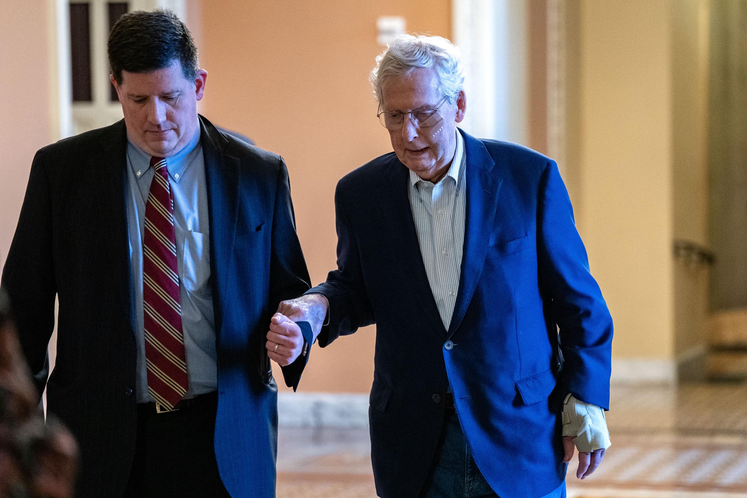 Senator Mitch McConnell is assisted by staff after tripping and injuring his wrist and face in Washington, D.C. on December 11, 2024 | Source: Getty Images