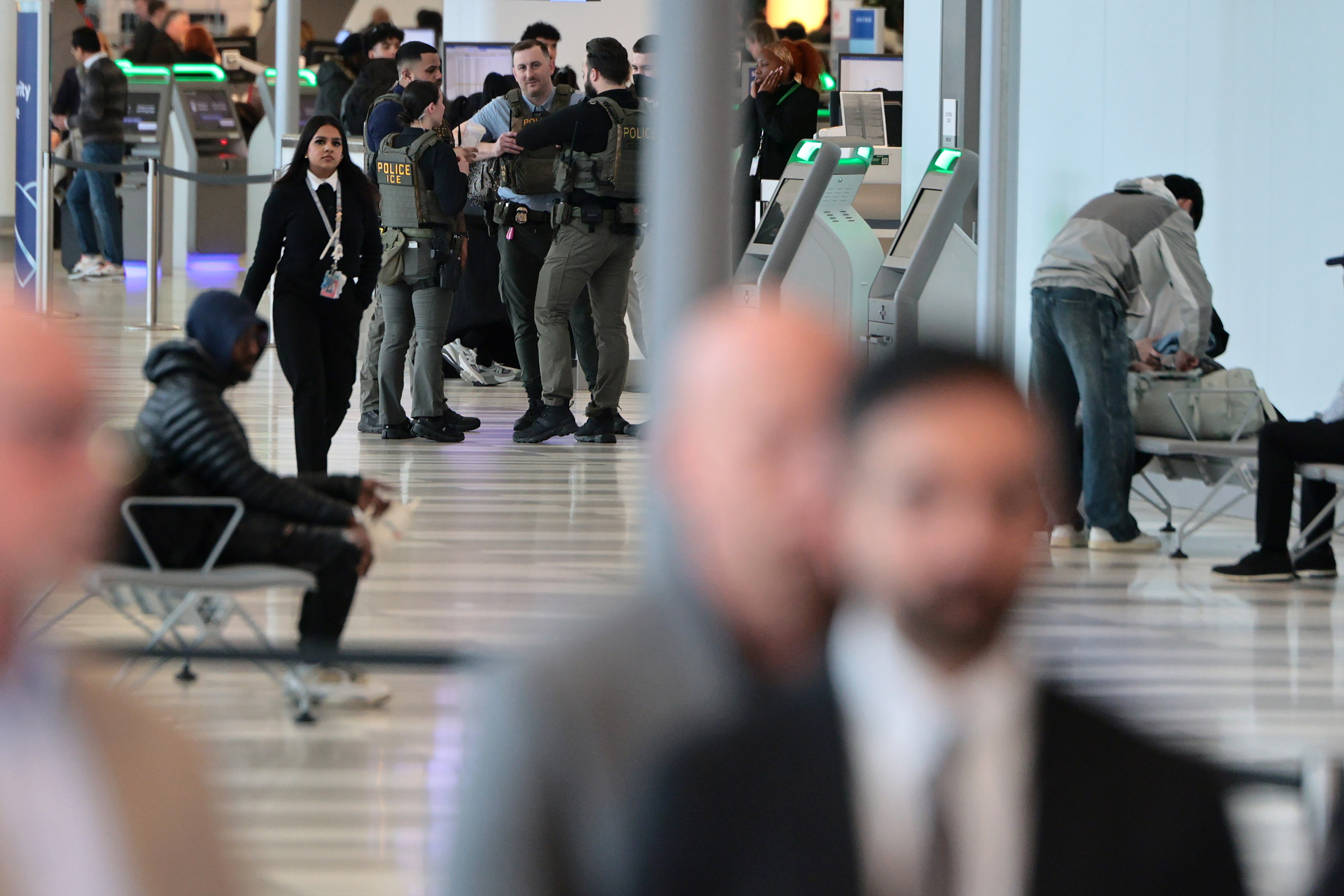 ICE agents stand inside LaGuardia Airport terminal following the crash in New York City, March 23, 2026 | Source: Getty Images