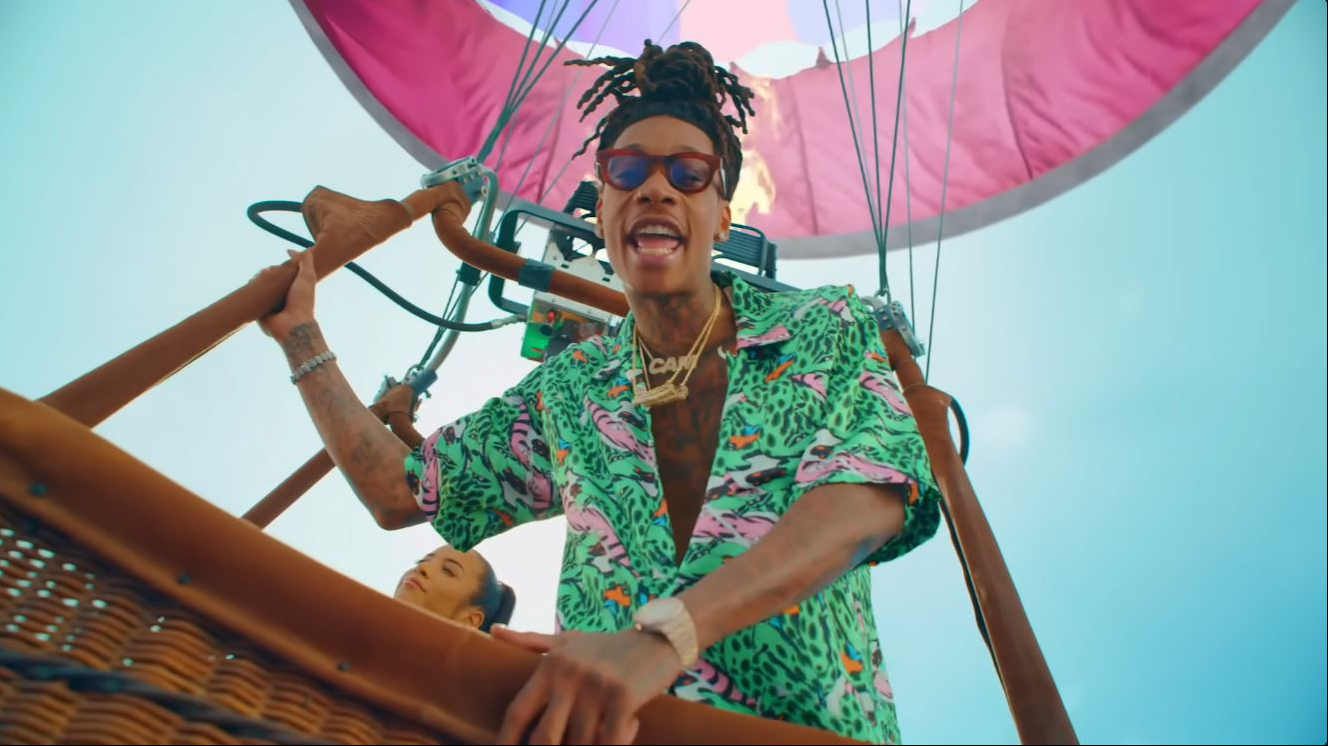 Wiz Khalifa pairs light-brown Thierry Lasry "DARKSIDY" sunglasses with a colorful patterned shirt in the "Contact" music video. | Source: YouTube/Wiz Khalifa
