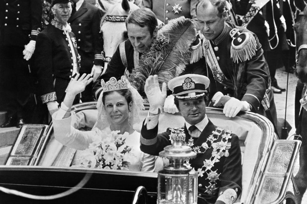 King Carl XVI Gustaf and his new bride Queen Silvia on a carriage procession through Stockholm on their wedding day | Source: Getty Images
