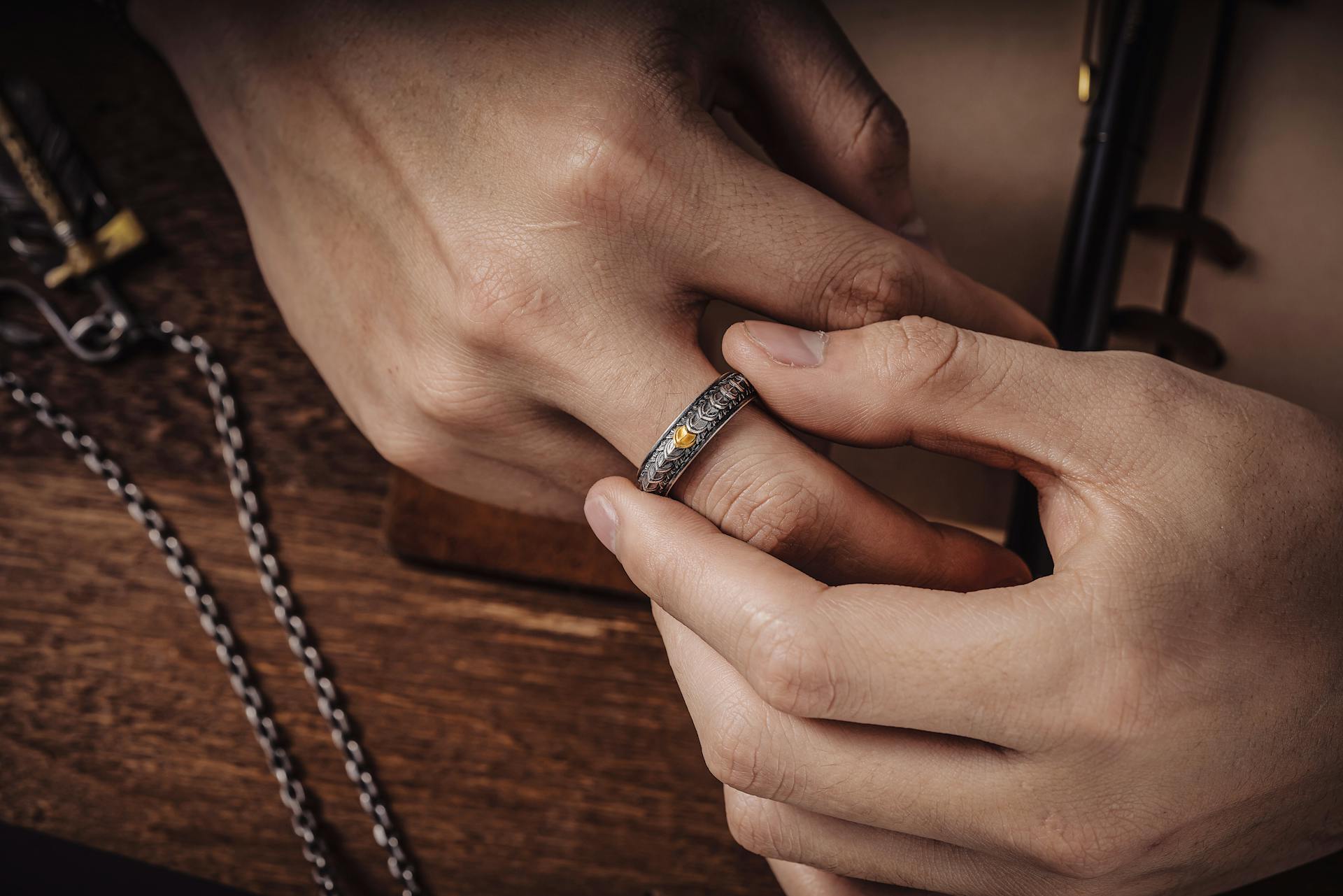 A closeup of a woman trying to remove her ring | Source: Pexels