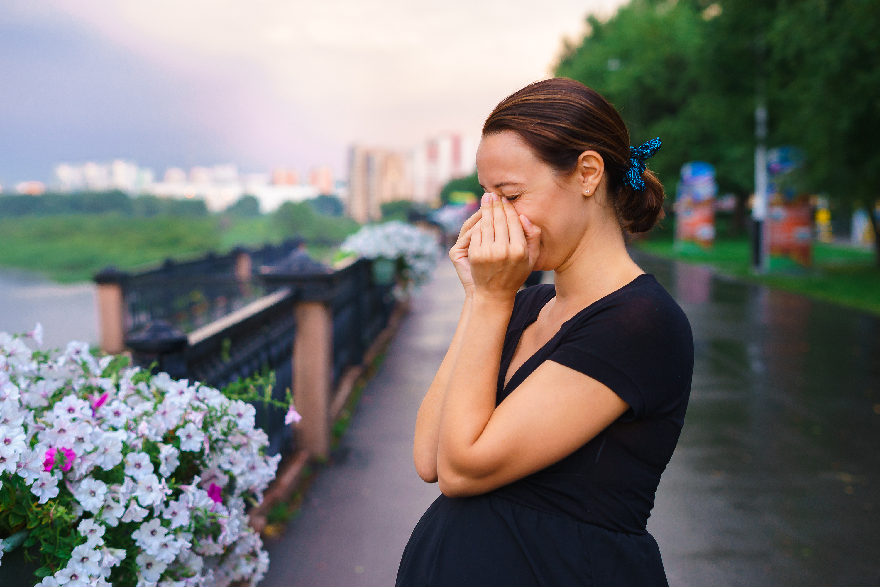 A sad pregnant woman crying in the street | Source: Shutterstock