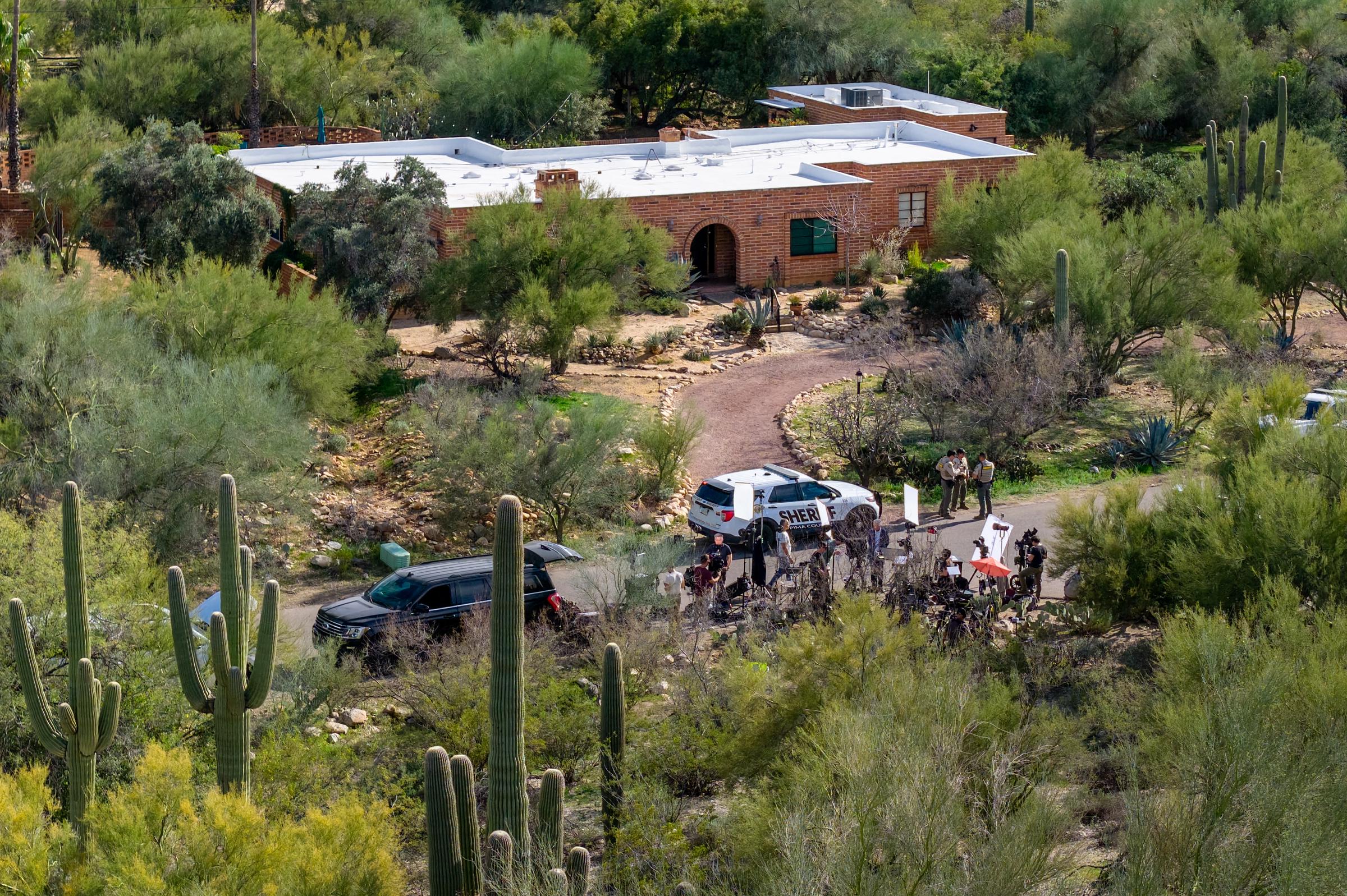 In an aerial view, law enforcement and news broadcasters are stationed outside of Nancy Guthrie's residence in Tucson, Arizona  on February 10, 2026. | Source: Getty Images
