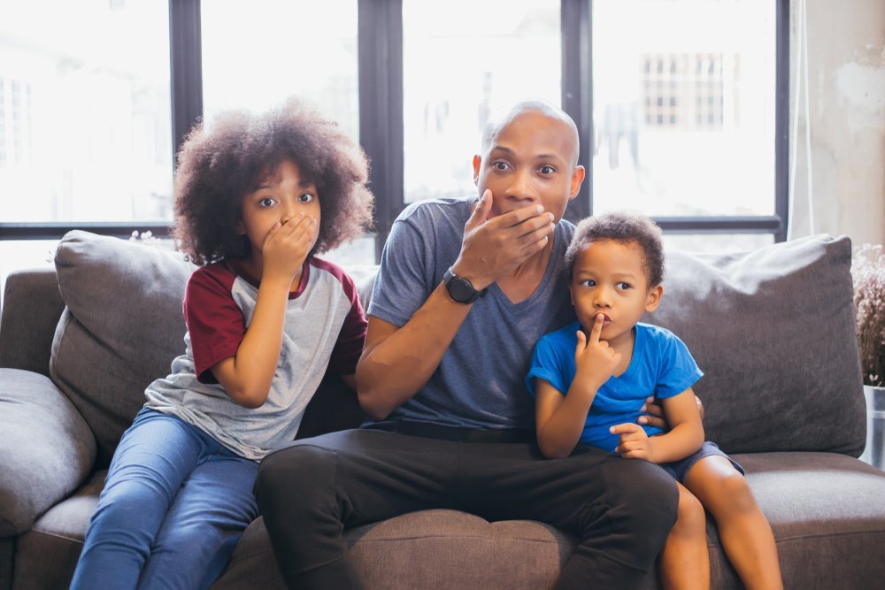 Family looking frightened from something they're watching | Photo: Shutterstock