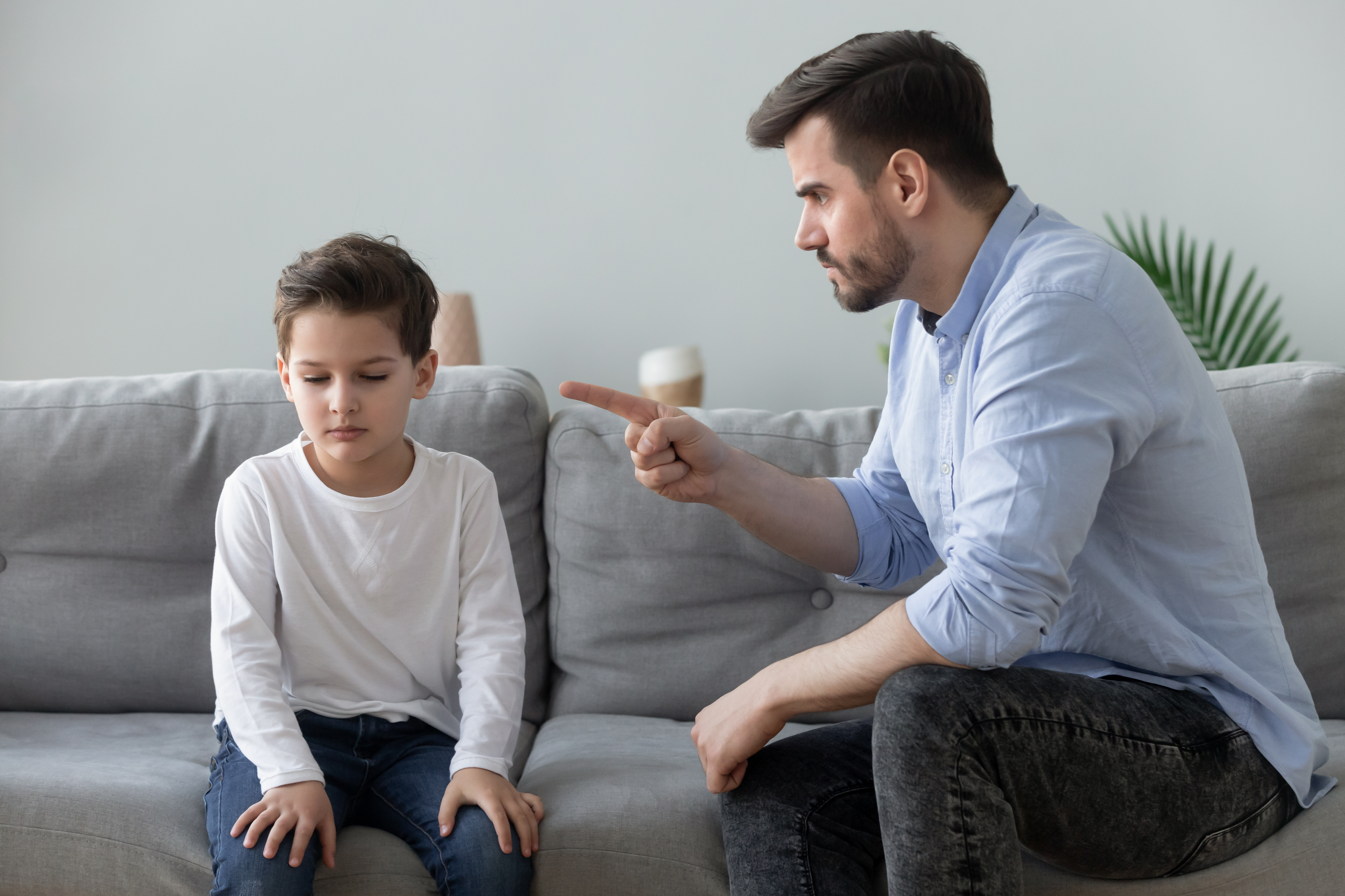 A young father is pictured disciplining his little son | Source: Shutterstock
