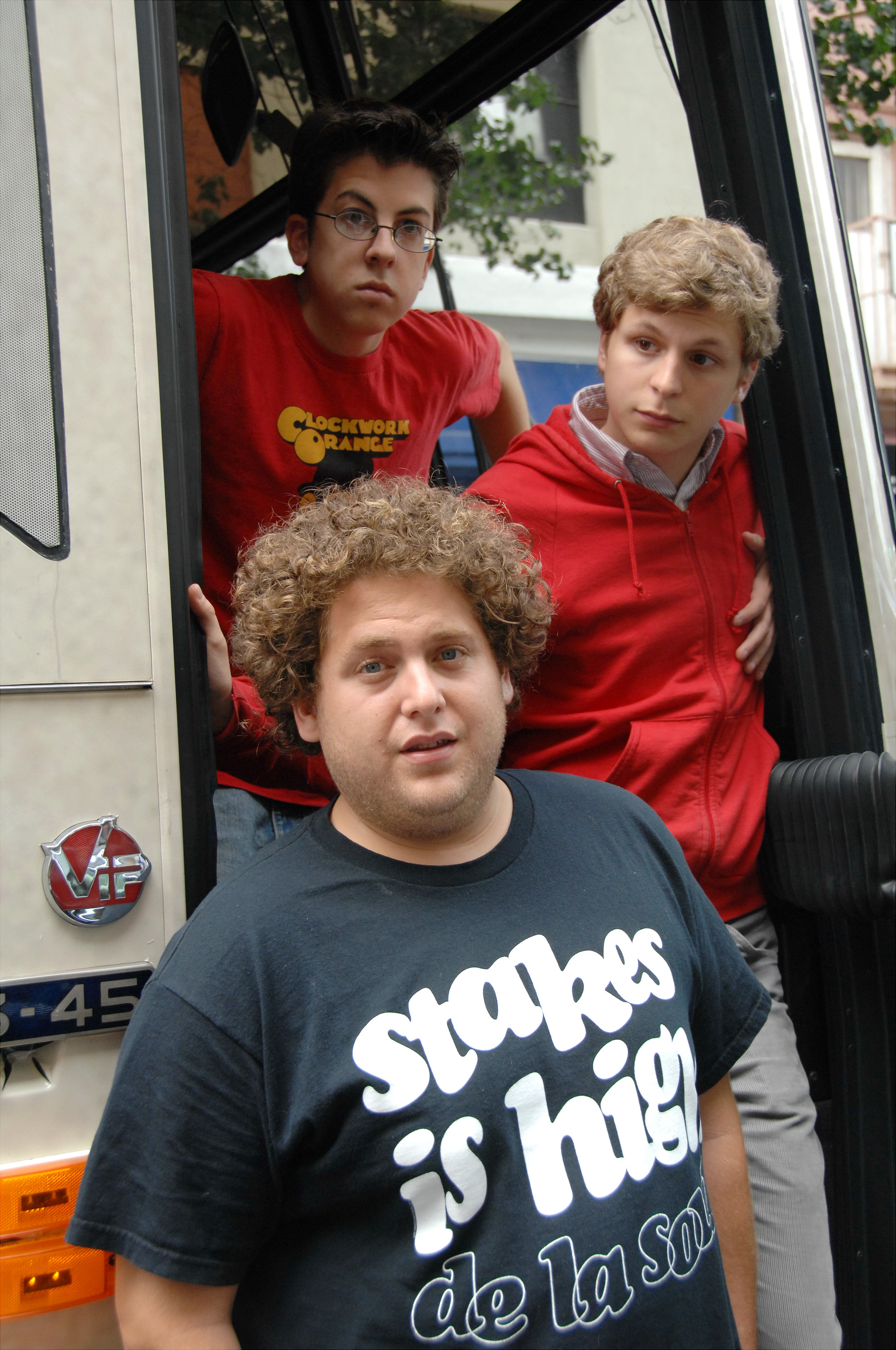 Christopher Mintz-Plasse, Michael Cera and Jonah Hill (clockwise from top) are pictured as they walk out of a studio bus in front of Bowlmor Lanes where they're promoting their new movie "Superbad" on August 27, 2007 | Source: Getty Images