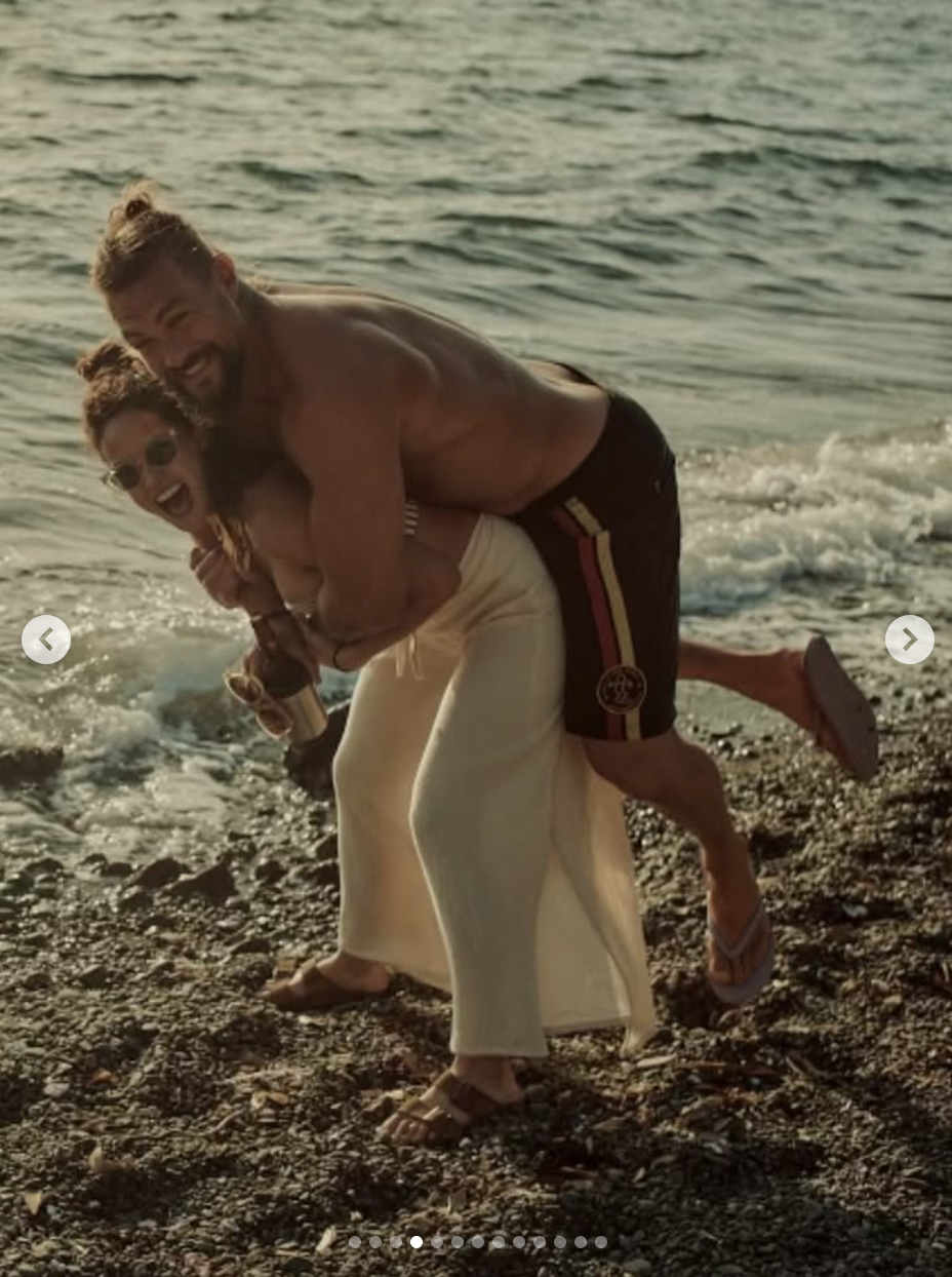 Jason Momoa appears to playfully piggyback on Adria Arjona as they share a laugh by the beach, in a photo shared on August 1, 2025 | Source: Instagram/adriaarjona