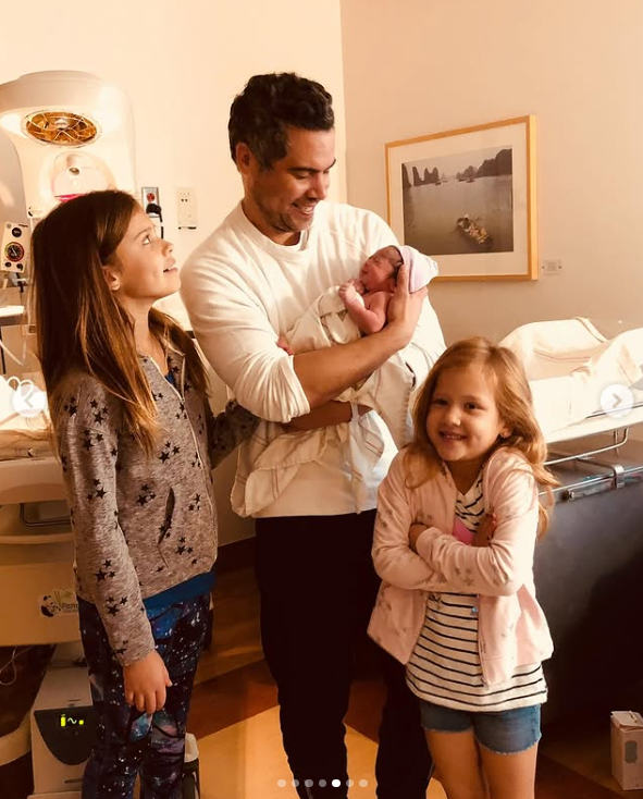 Cash Warren holds their newborn child with their older daughters by his side, as posted on May 19, 2024 | Source: Instagram.com/jessicaalba