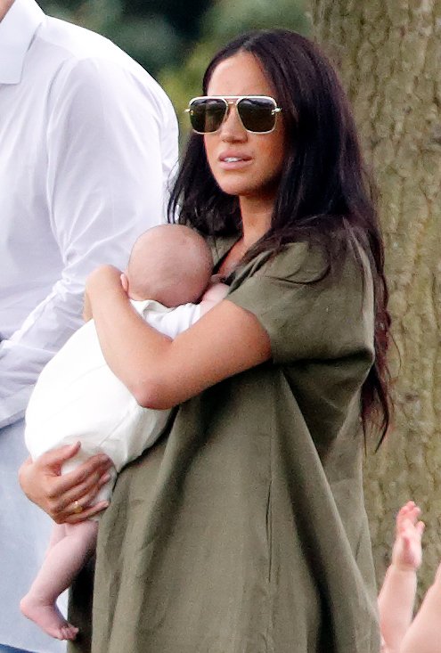 Duchess Meghan holding baby Archie while watching Prince Harry play at the King Power Royal Charity Polo Day | Photo: Getty Images