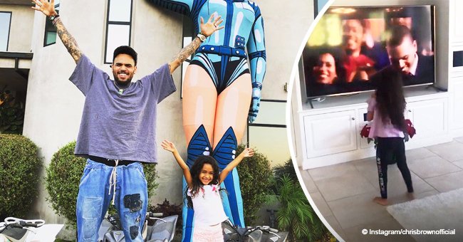 Chris Brown's daughter gets excited while watching her dad perform in a movie on TV