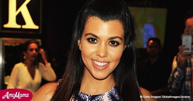 Kourtney Kardashian flashes her toned abs in a red crop top and tiny black briefs