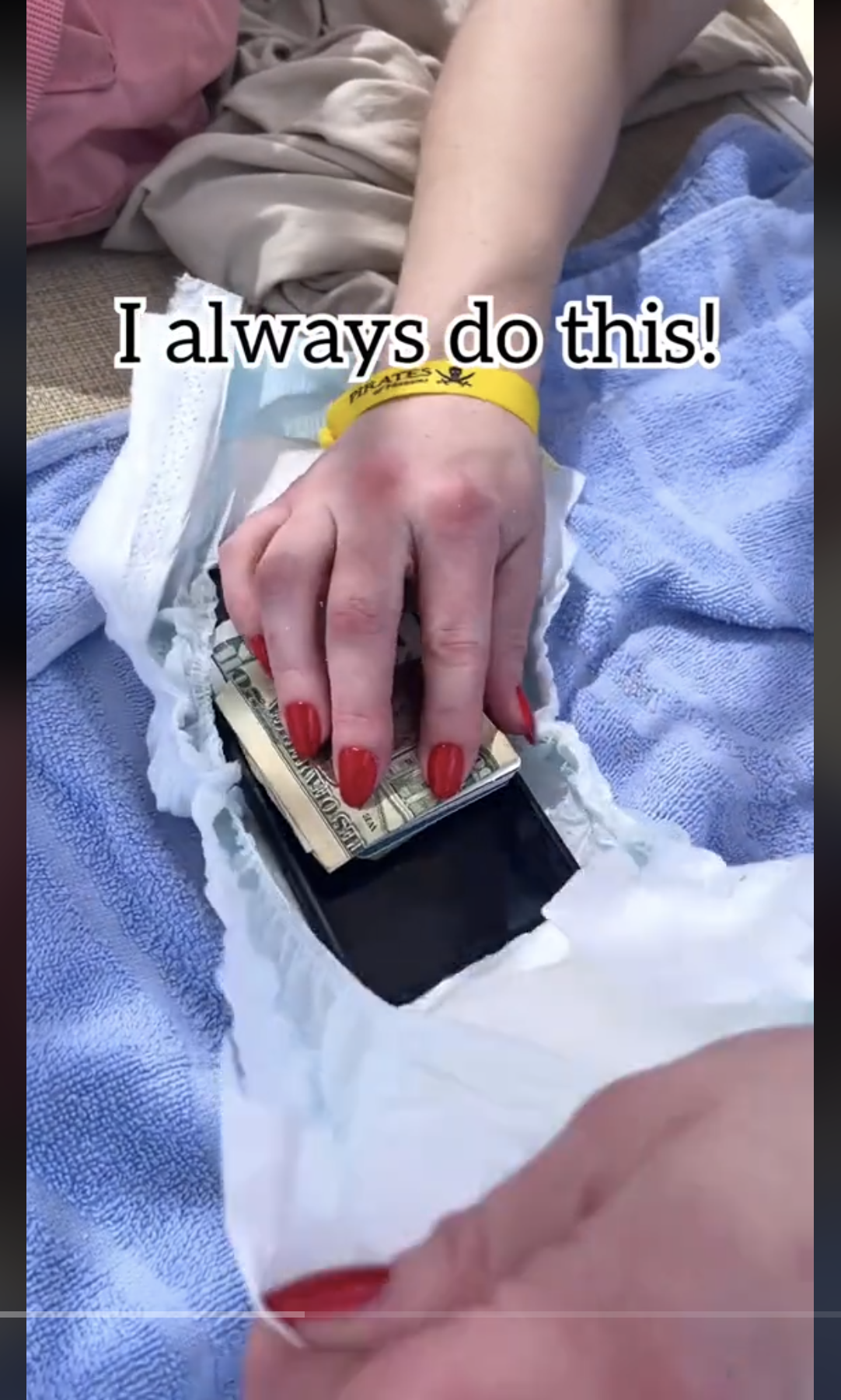 A woman placing her mobile phone and money inside a diaper, as seen in a video May 19, 2024 | Source: TikTok/@jeffandlaurenshow