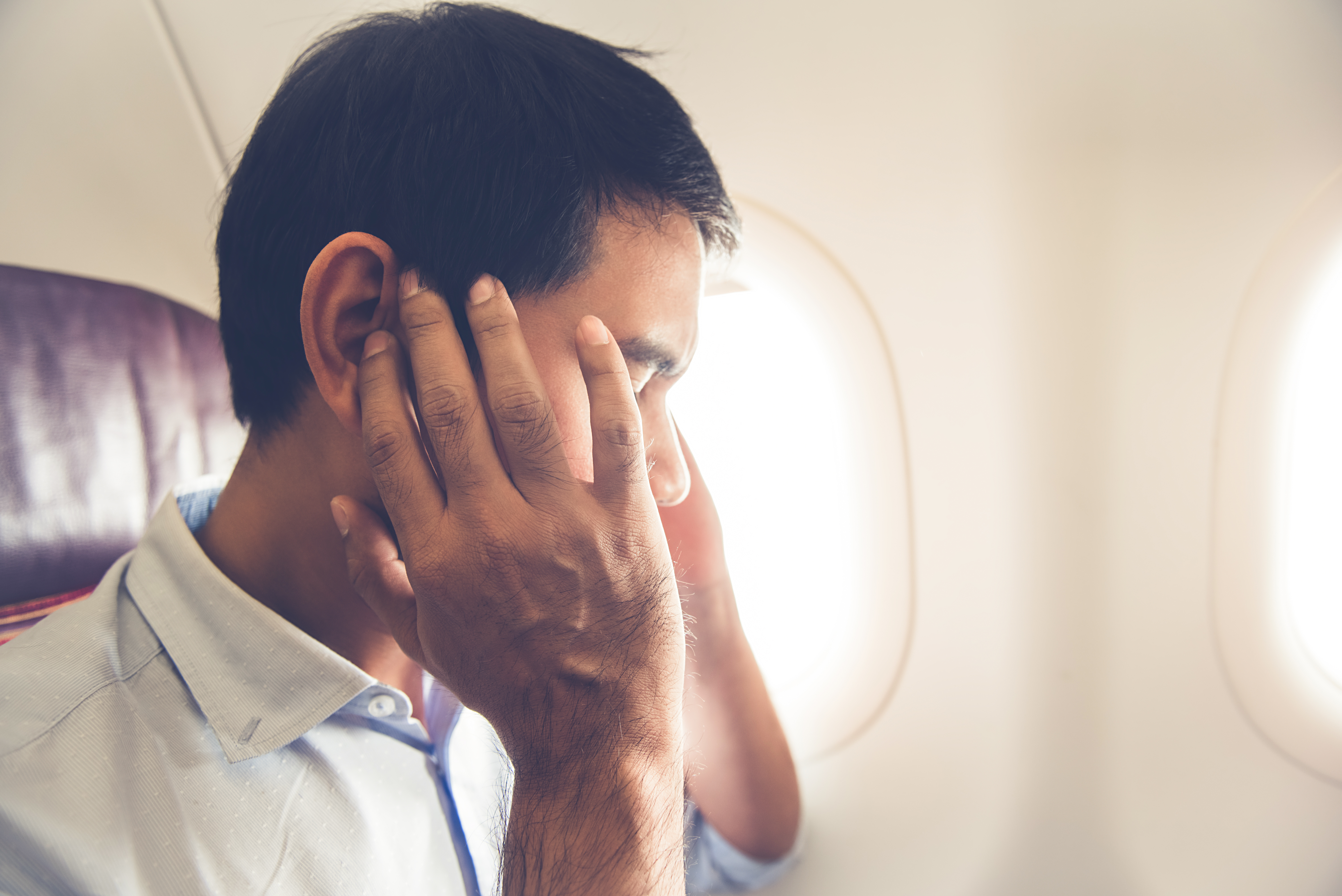 A frustrated male airplane passenger | Source: Shutterstock